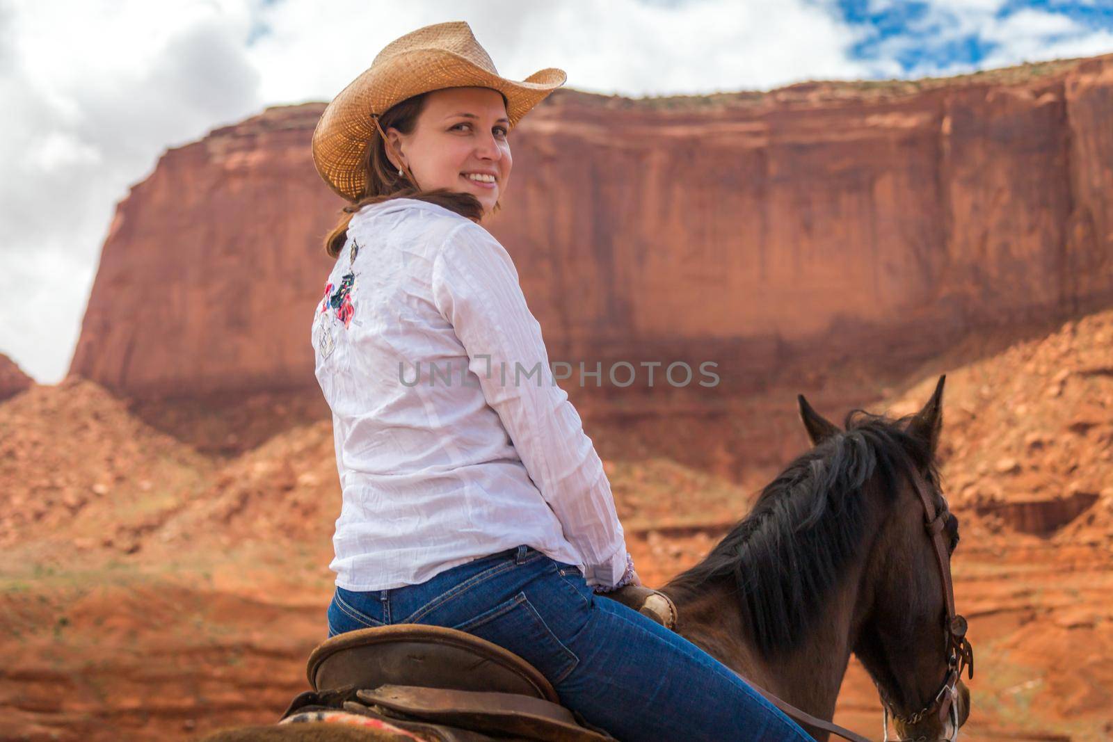 Cowboy woman on a horse in Monument Valley Navajo Tribal Park in USA