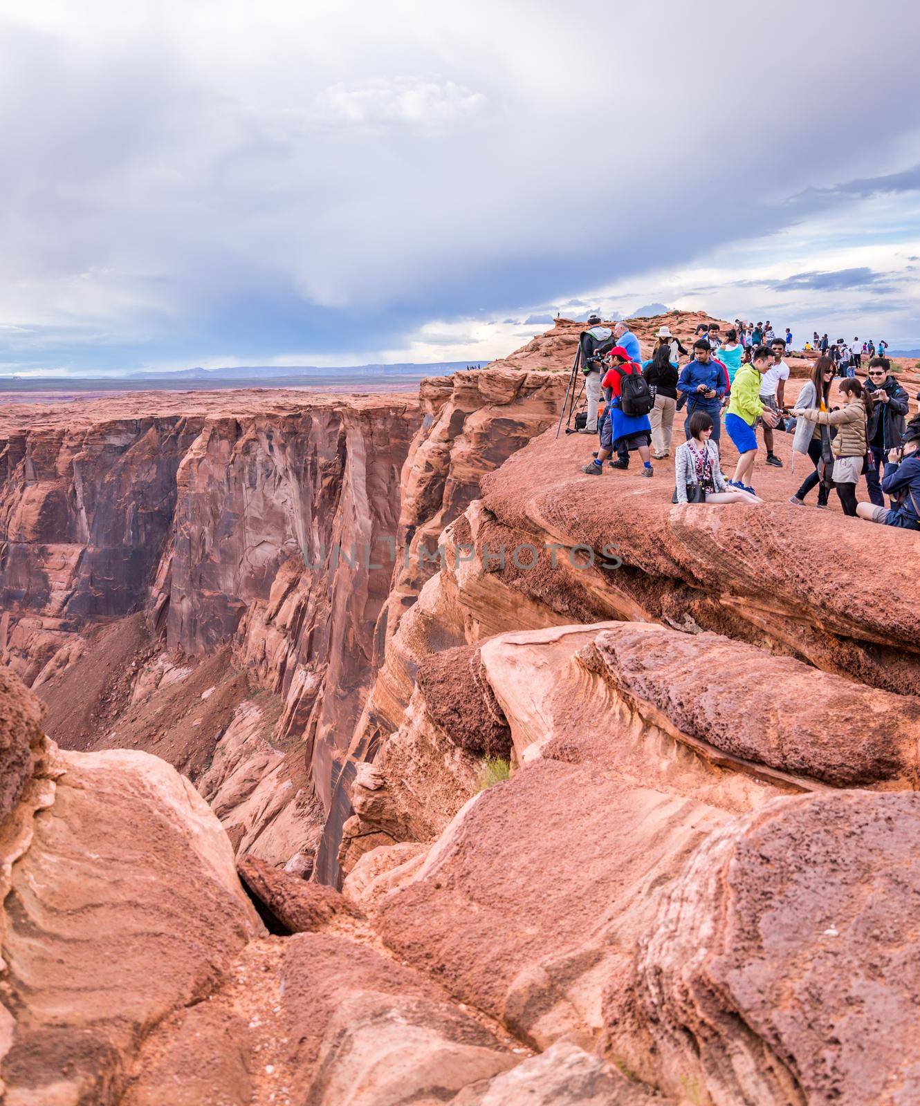 PAGE, ARIZONA - MAY 25: Hikers at Horseshoe Bend on May 25, 2015 in Page AZ,USA. Thousands of people from all over the world visit this unique place every year.