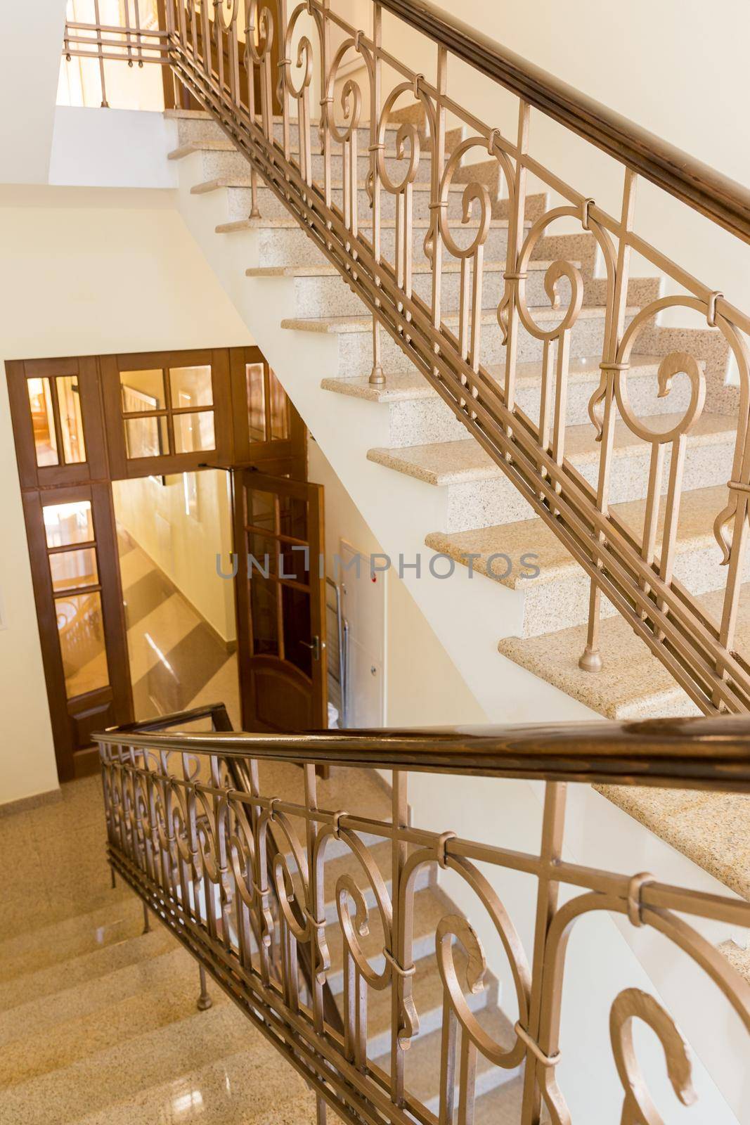 old-styled marble staircase with handrails in a hotel