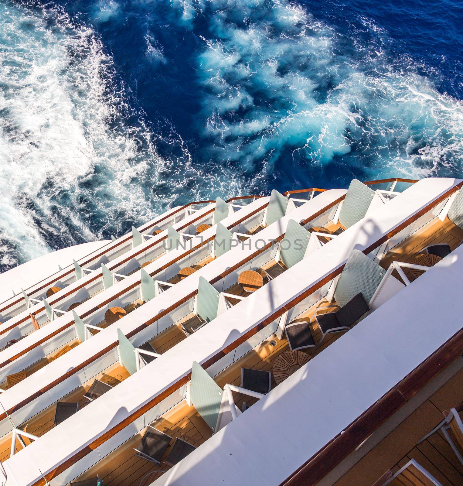 Balconies on a backof Cruise ship, decks with wake or trail on ocean surface