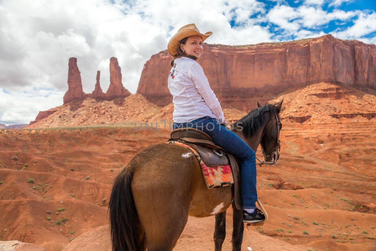 Cowboy woman on a horse in Monument Valley Navajo Tribal Park in USA