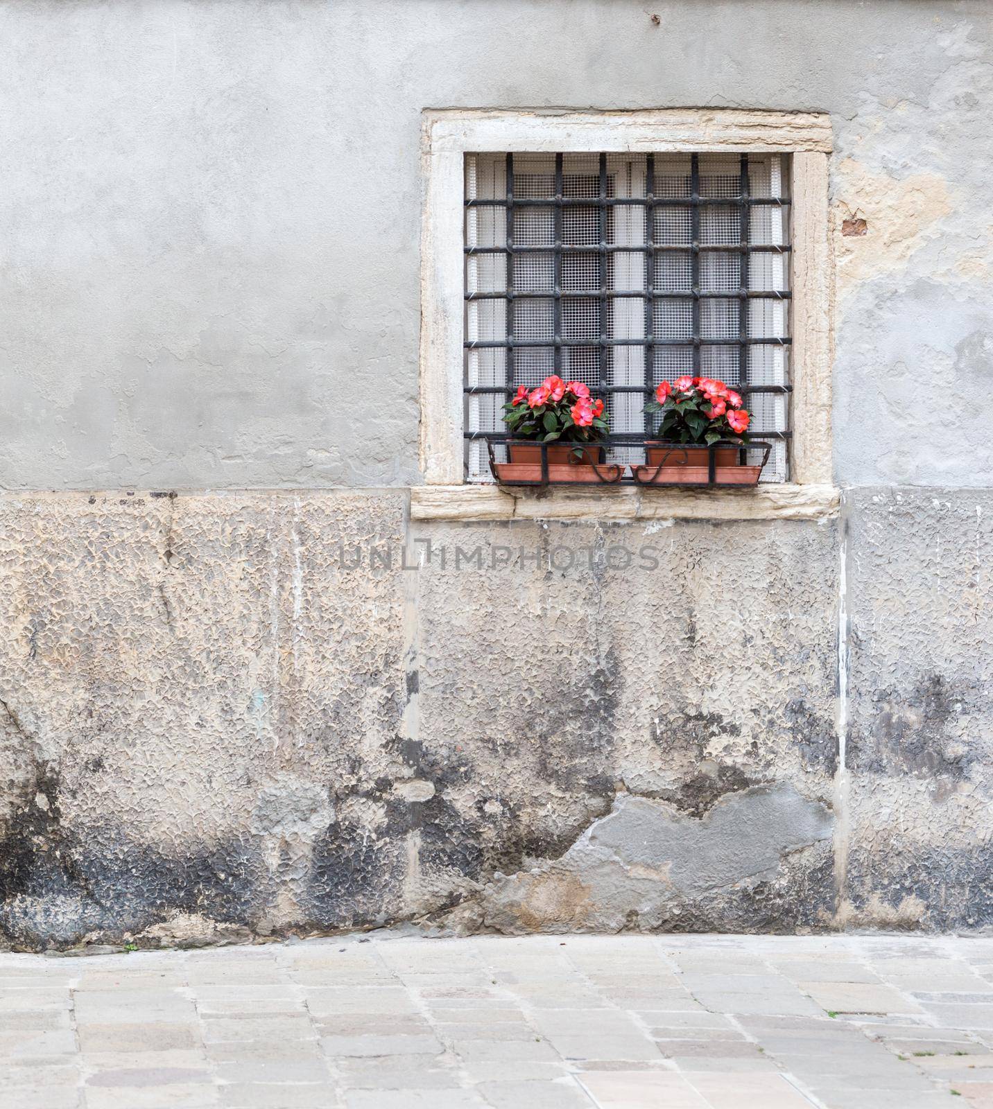 Window with bars in the old house of the city of Venice Italy