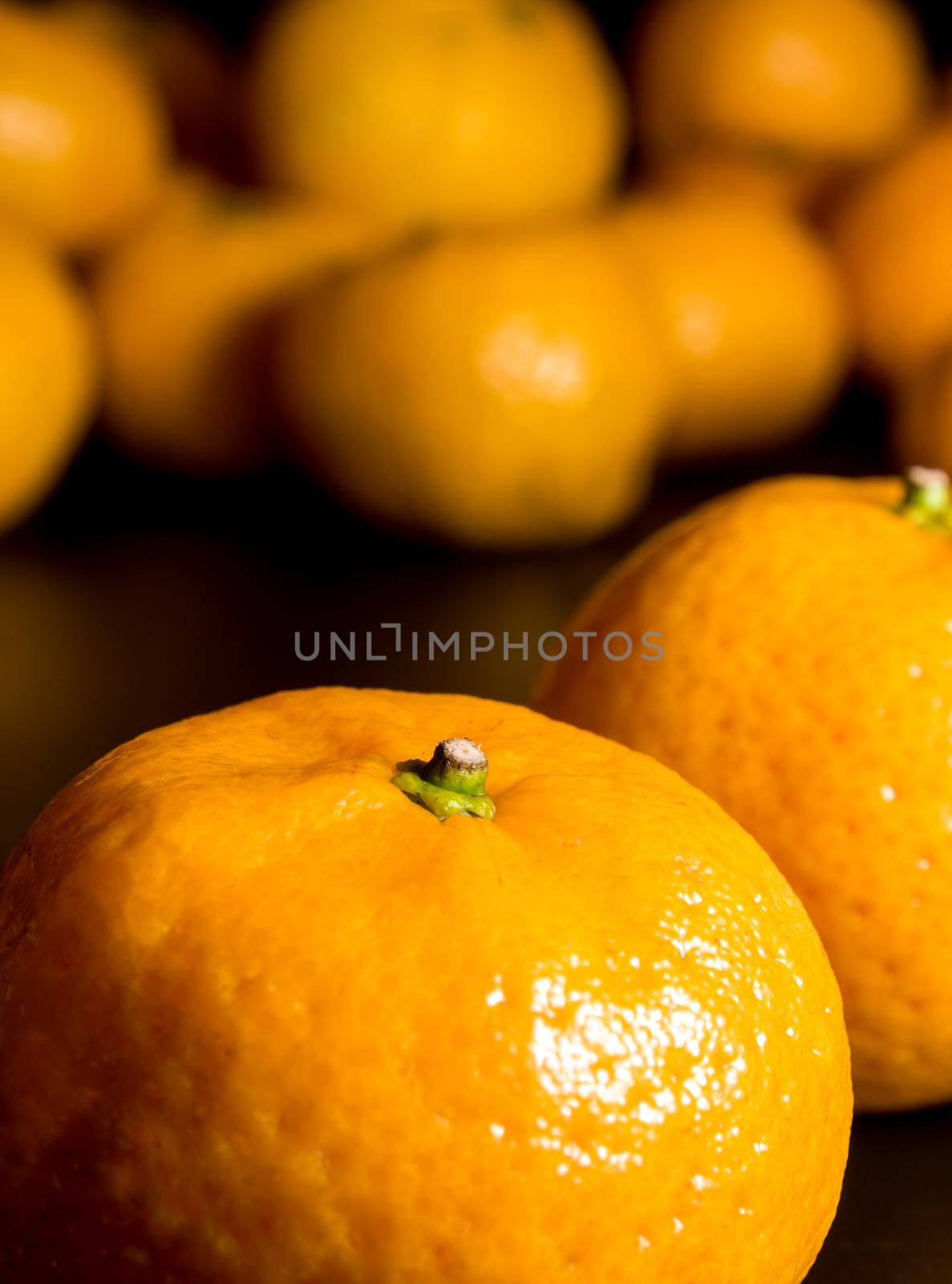 Close-up of Water droplet on glossy surface of freshness orange on black background