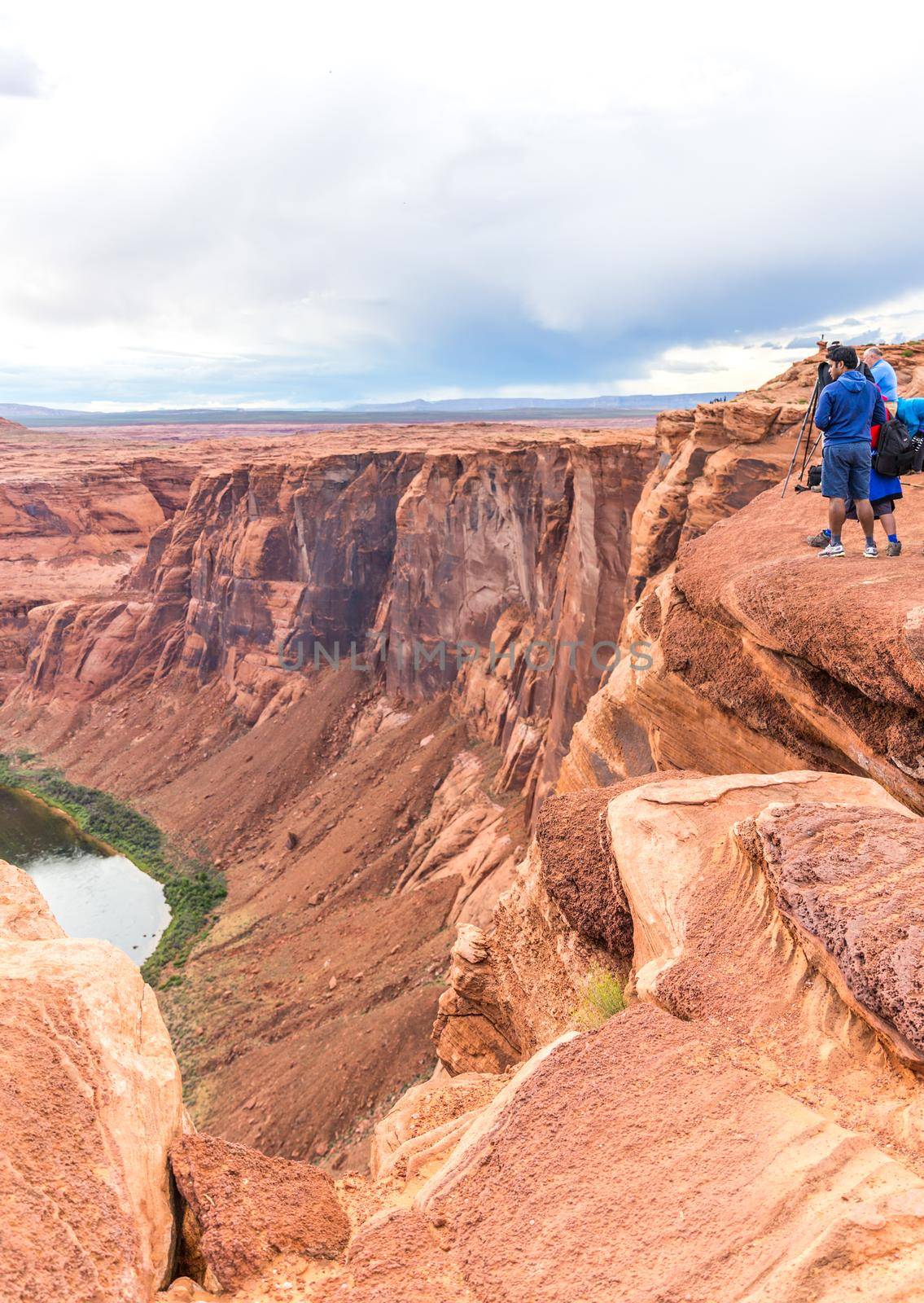 PAGE, ARIZONA - MAY 25: Hikers at Horseshoe Bend on May 25, 2015 in Page AZ,USA. Thousands of people from all over the world visit this unique place every year.