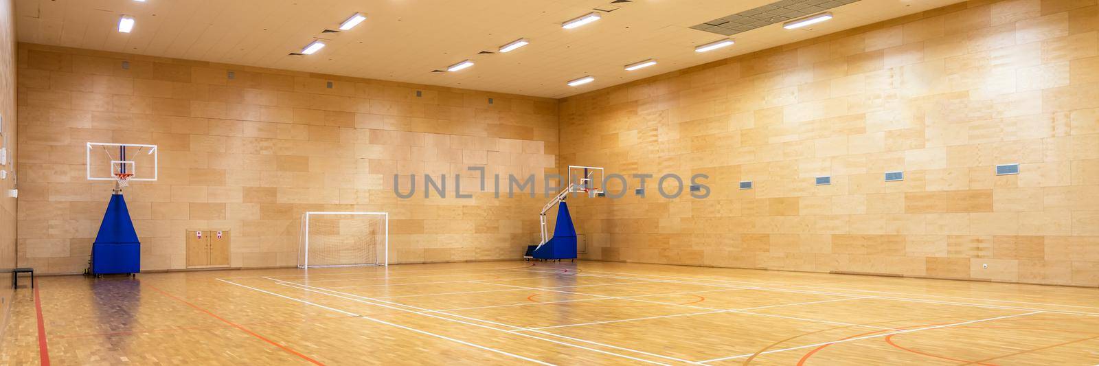 Interior of empty modern basketball or soccer indoor sport court by Mariakray