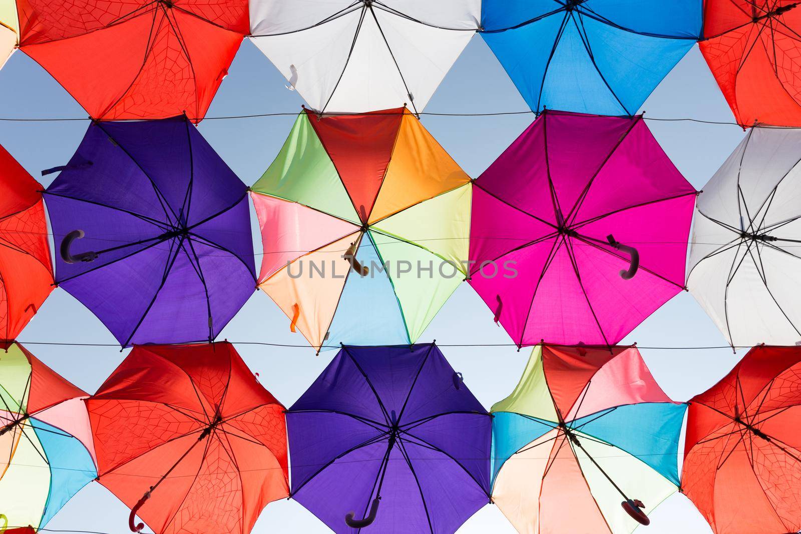 colorful umbrellas hanging on the sky background