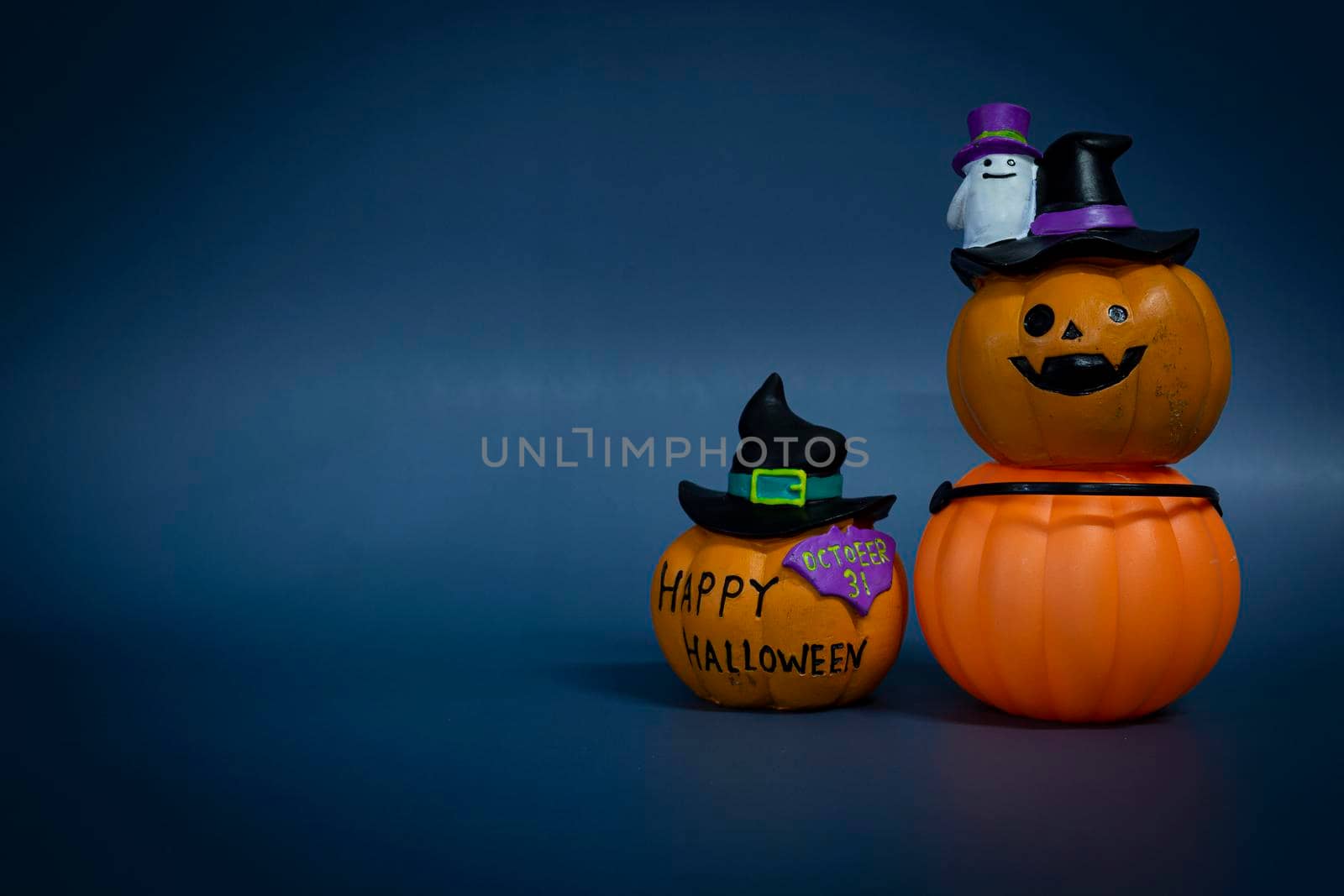 Halloween glitter pumpkin jack o lantern on a dark blue background. Halloween concept backdrop