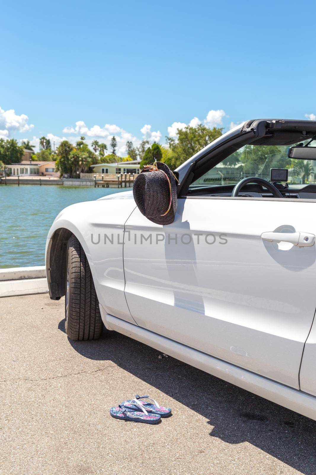 Convertible car with hat hanging on mirror