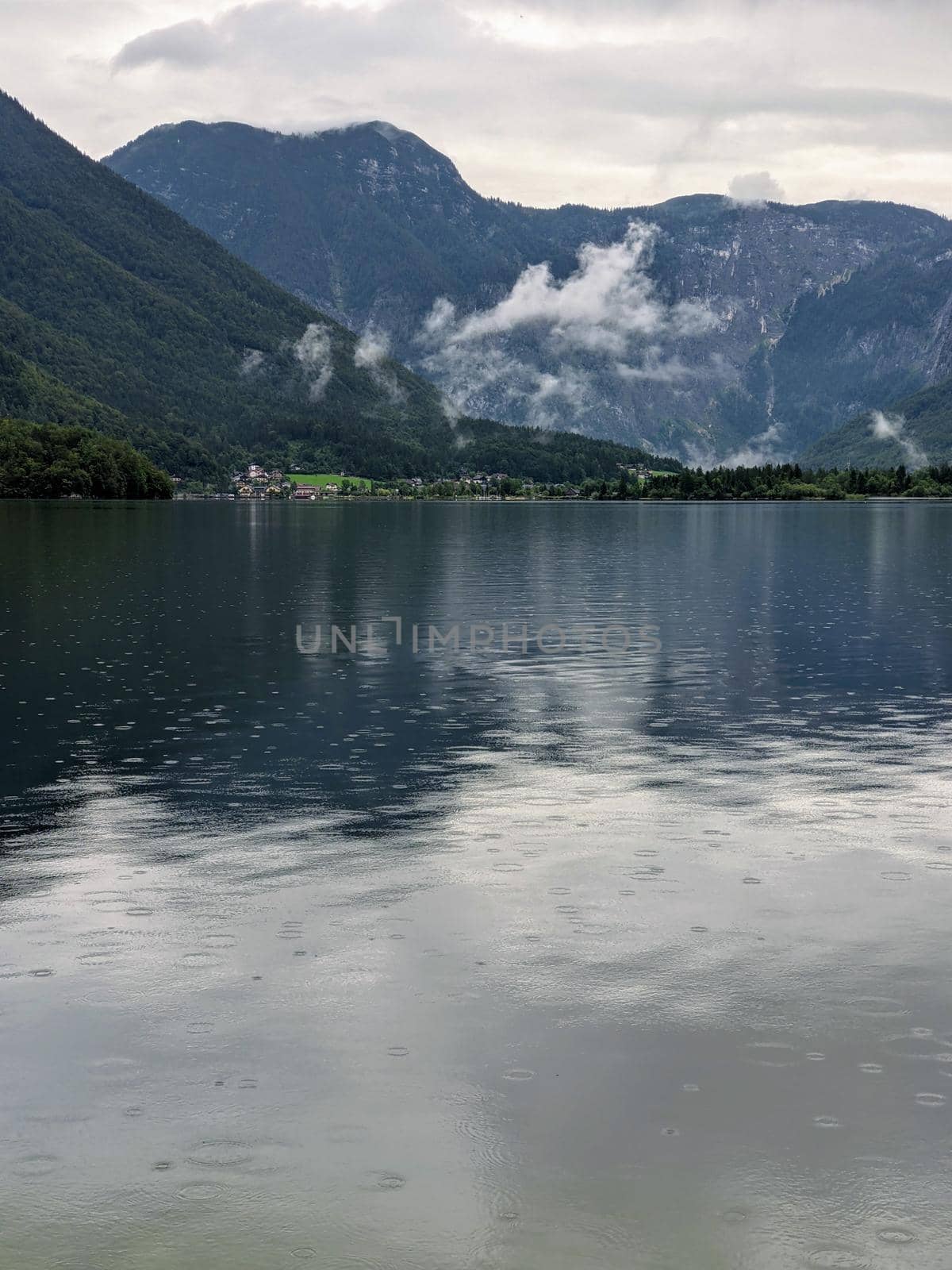 Alpine lake Hallstatter See during rain travel destination by weruskak