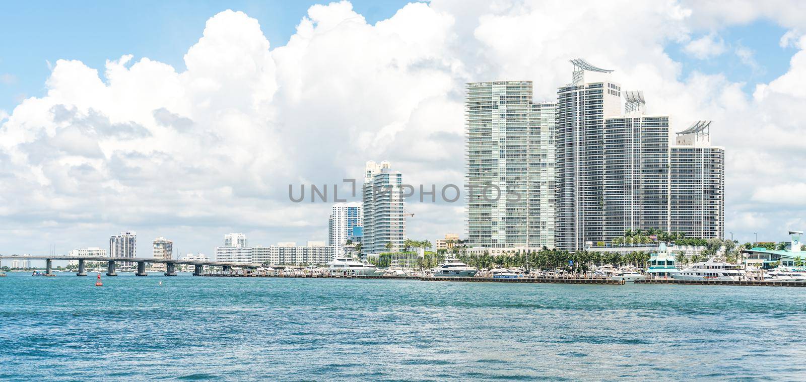 Miami, USA - September 11, 2019: Miami skyline with skyscrapers and bridge over sea by Mariakray
