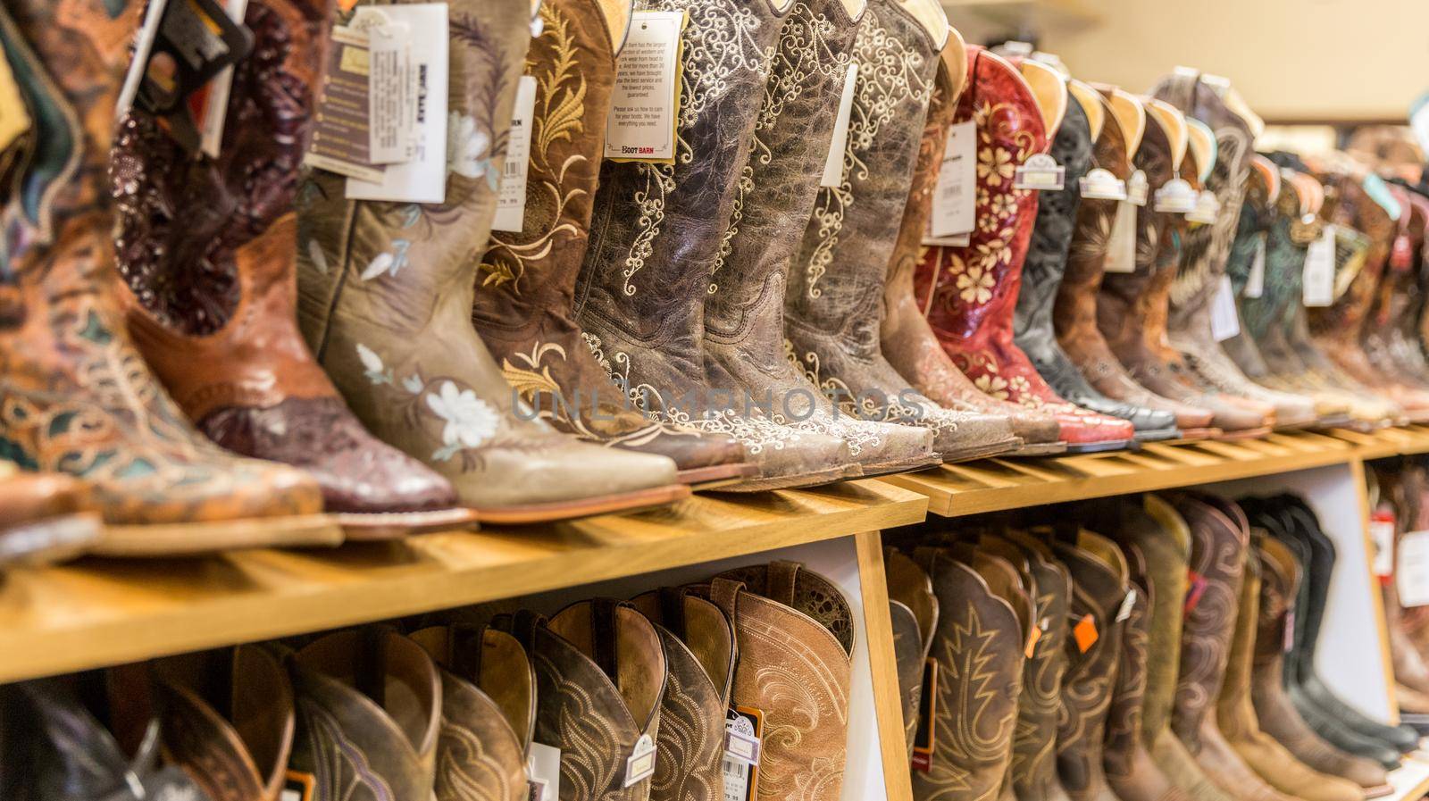 LOS ANGELES, CALIFORNIA, USA - MAY 20, 2015 - Close-up of new cowboy boots on shelf in Boot Barn store