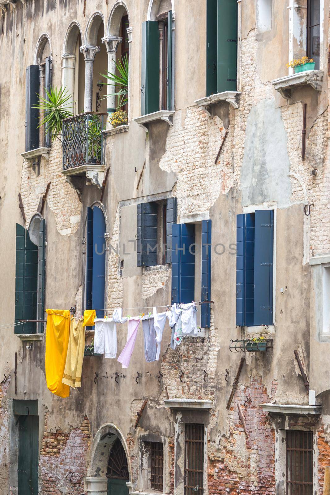 Clothes drying hanging high in Venice Italy by Mariakray