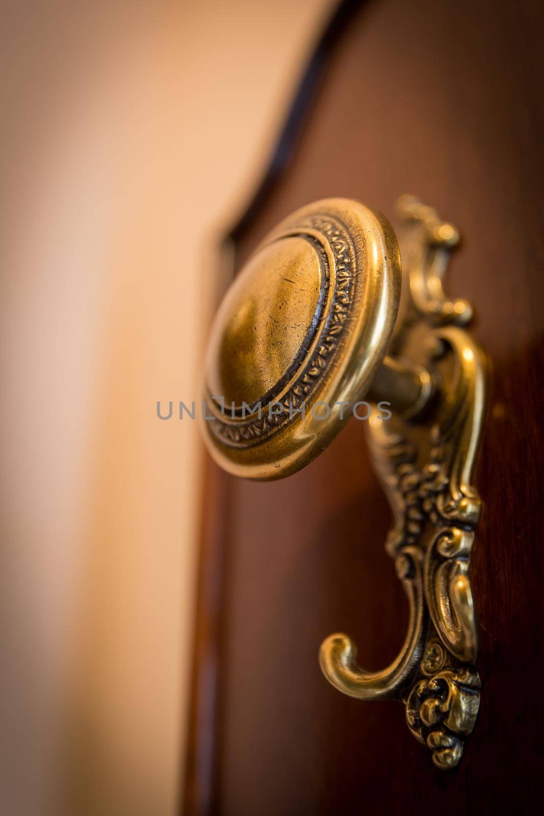 Old-fashioned golden coat hook in a lobby