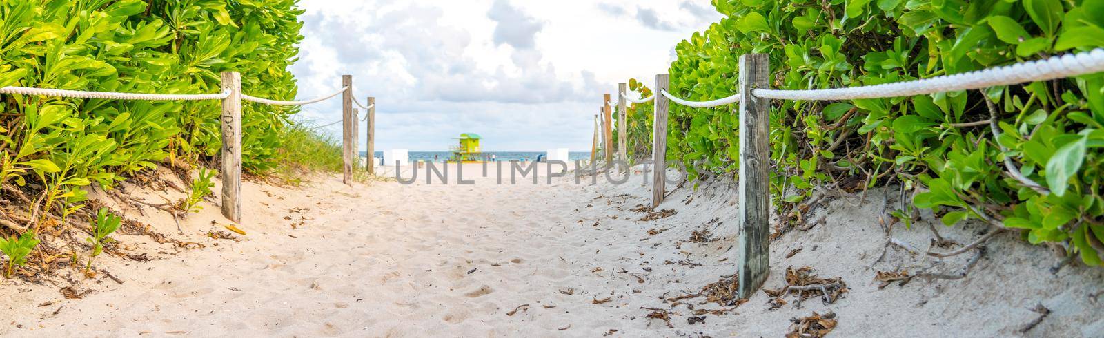 Pathway to the beach in Miami Florida with an ocean background