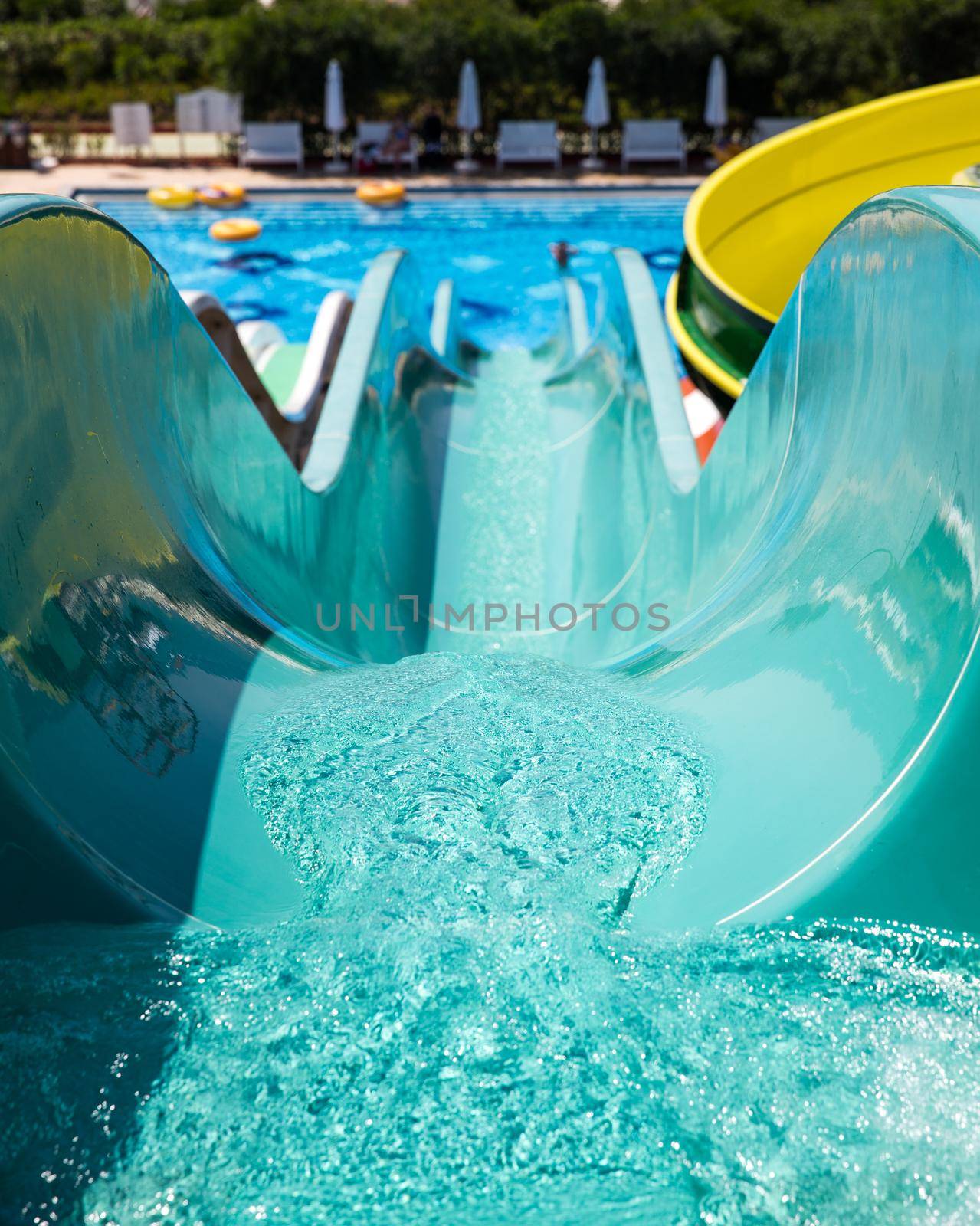 Colorful waterpark tubes and a swimming pool. Outdoor shot