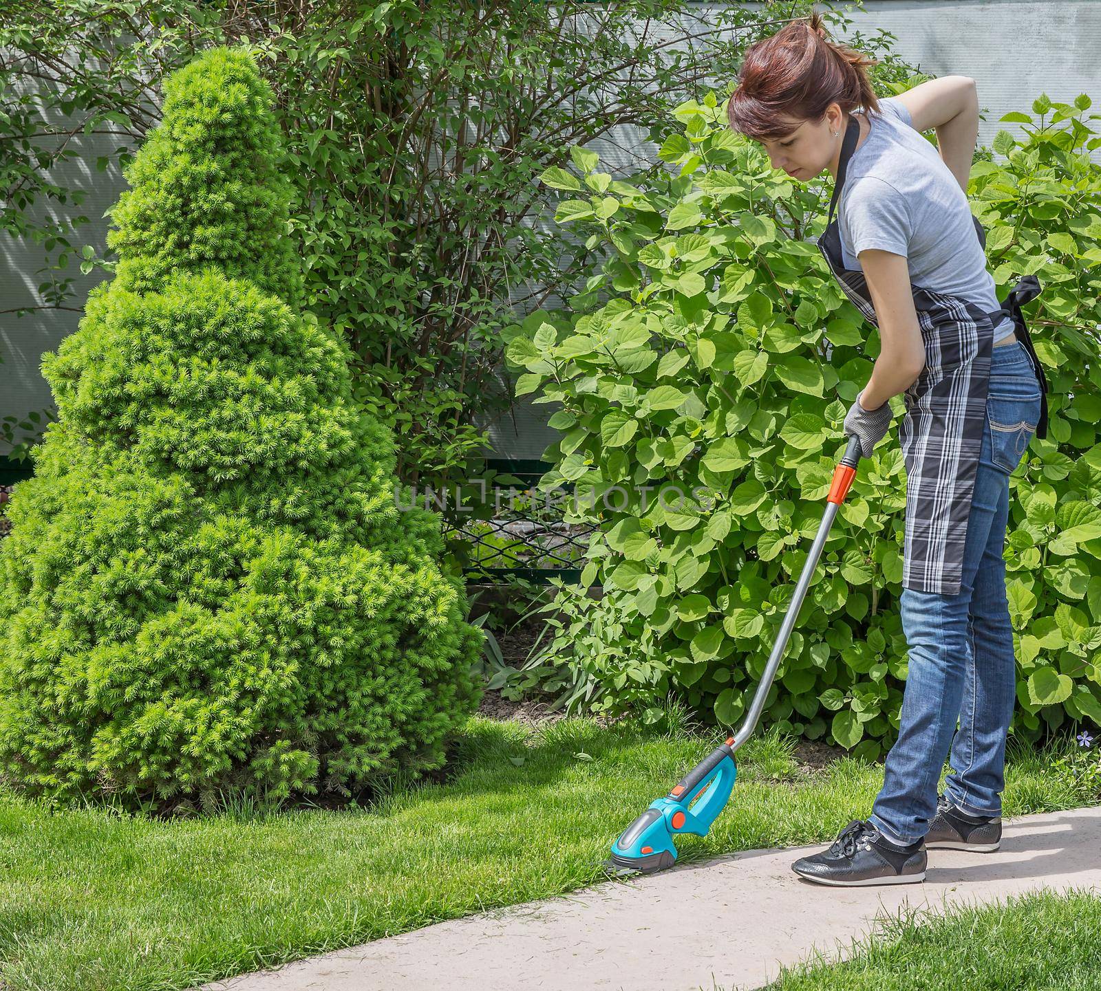 Happy female working in garden in summer