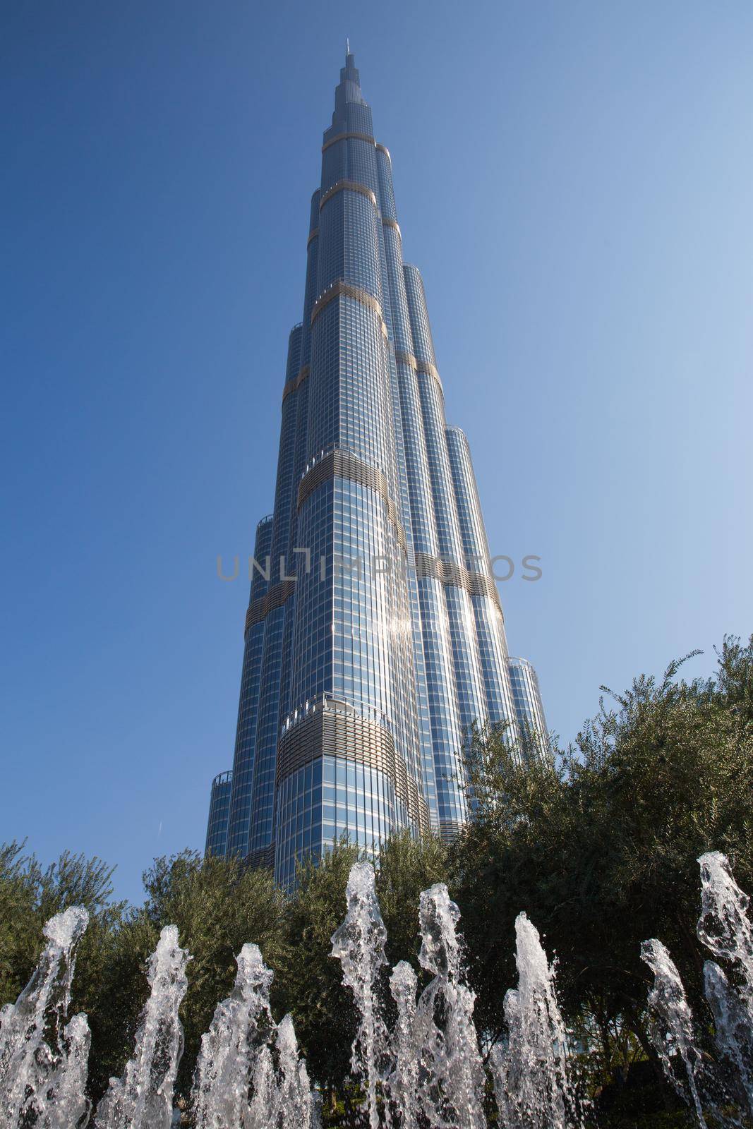 DUBAI, UNITED ARAB EMIRATES – JANUARY 20: Tower Burj Khalifa vanishing in blue sky on January 20, 2014 in Dubai. It is the tallest structure in world since 2010, 829.8 meters and one of the most visited tourist attractions in the world. by Mariakray