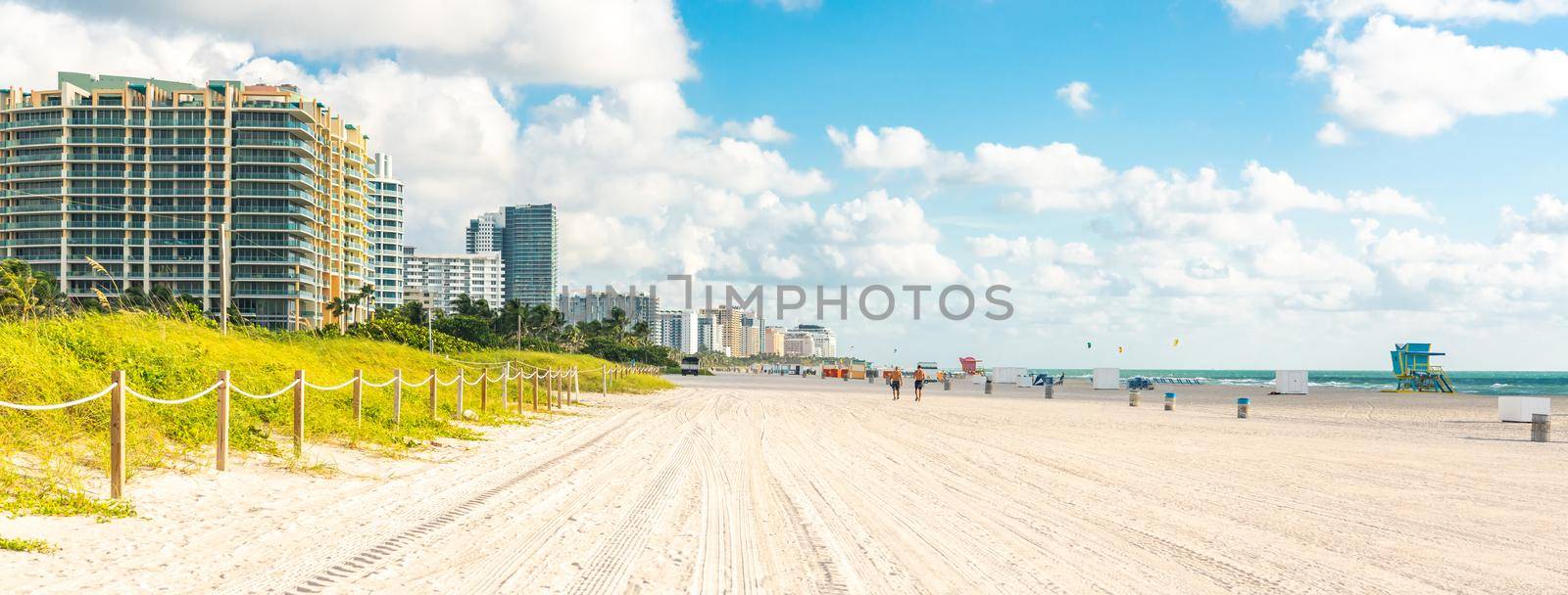 Wide South Beach in Miami, Florida with grass and buildings by Mariakray