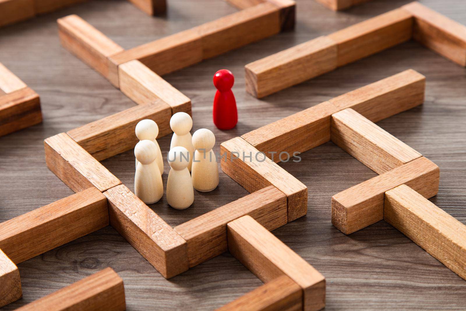 Leadership concept.Wooden miniature at the start point of puzzle maze wood block