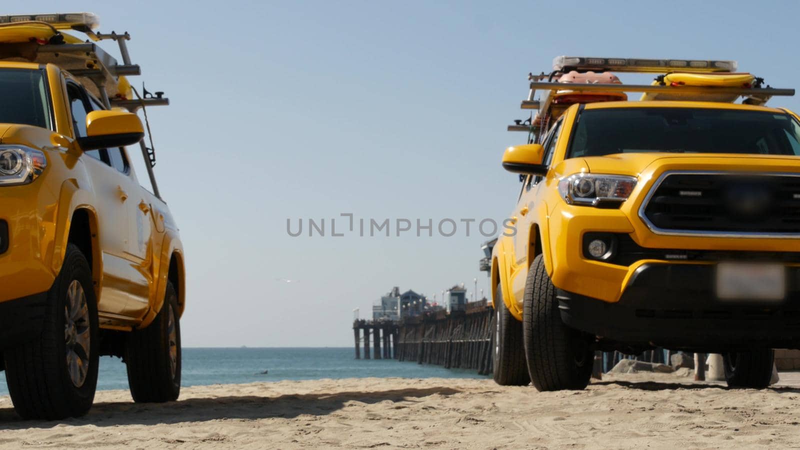 Yellow lifeguard car, ocean beach California USA. Rescue pick up truck, lifesavers vehicle. by DogoraSun