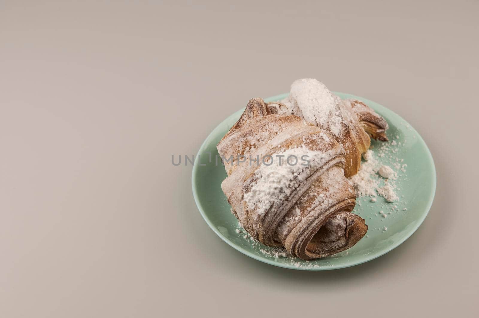 Two fresh croissants in plate on white background. Breakfast