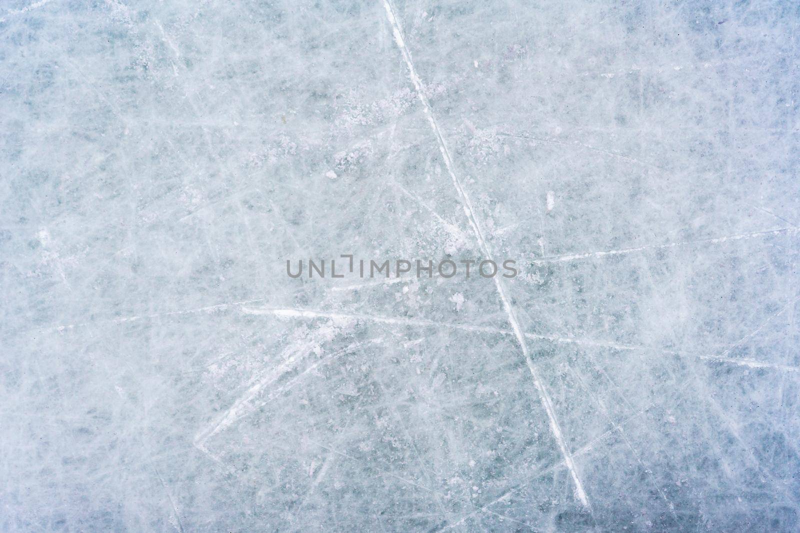 Ice background with marks from skating and hockey. blue texture