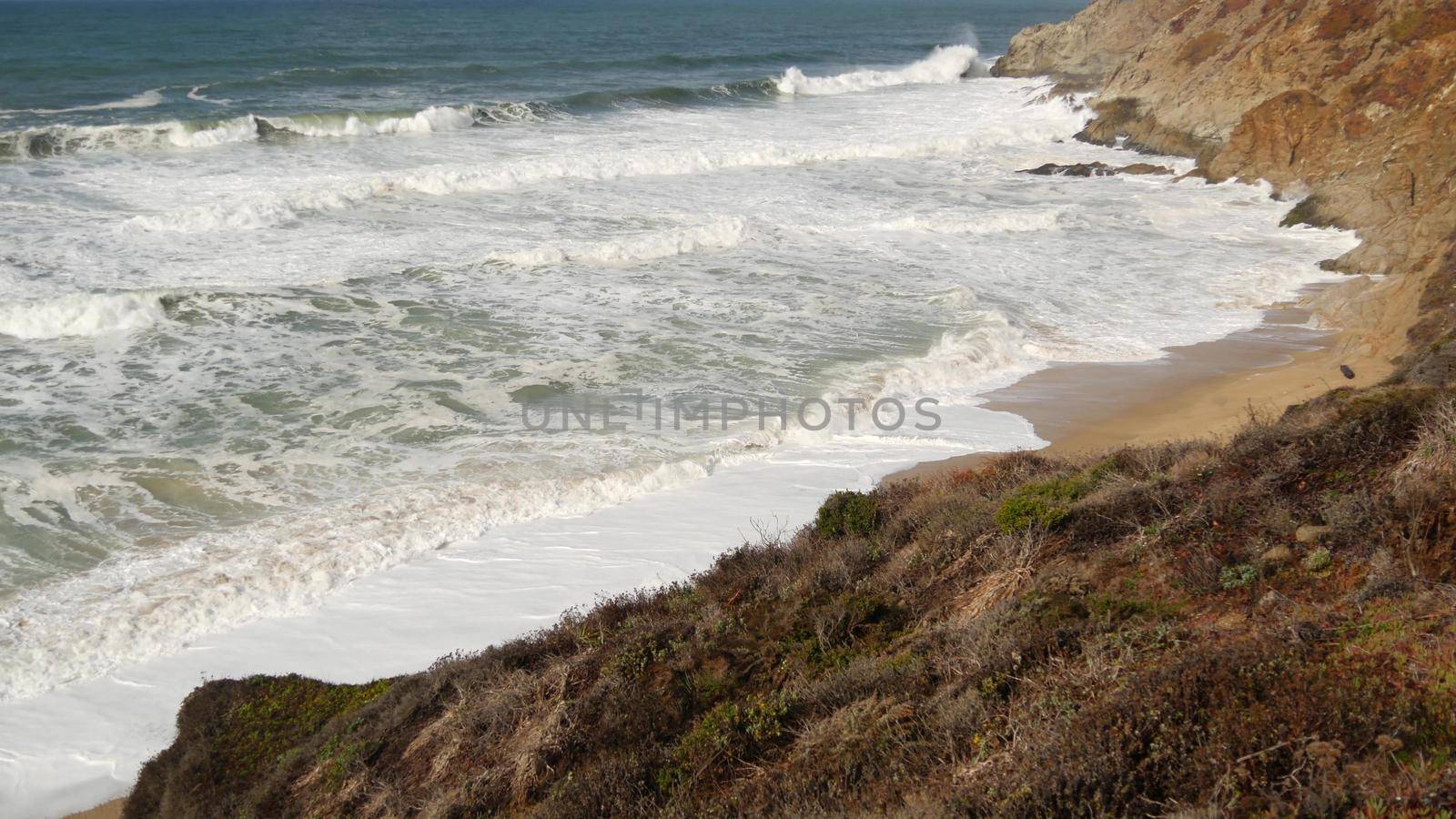 Ocean waves and rocks, Monterey, Northern California, USA. 17-mile drive near Big Sur, seaside golf tourist resort on Pacific Coast Highway. Splashing water and sea breeze of Pebble beach. Road trip by DogoraSun