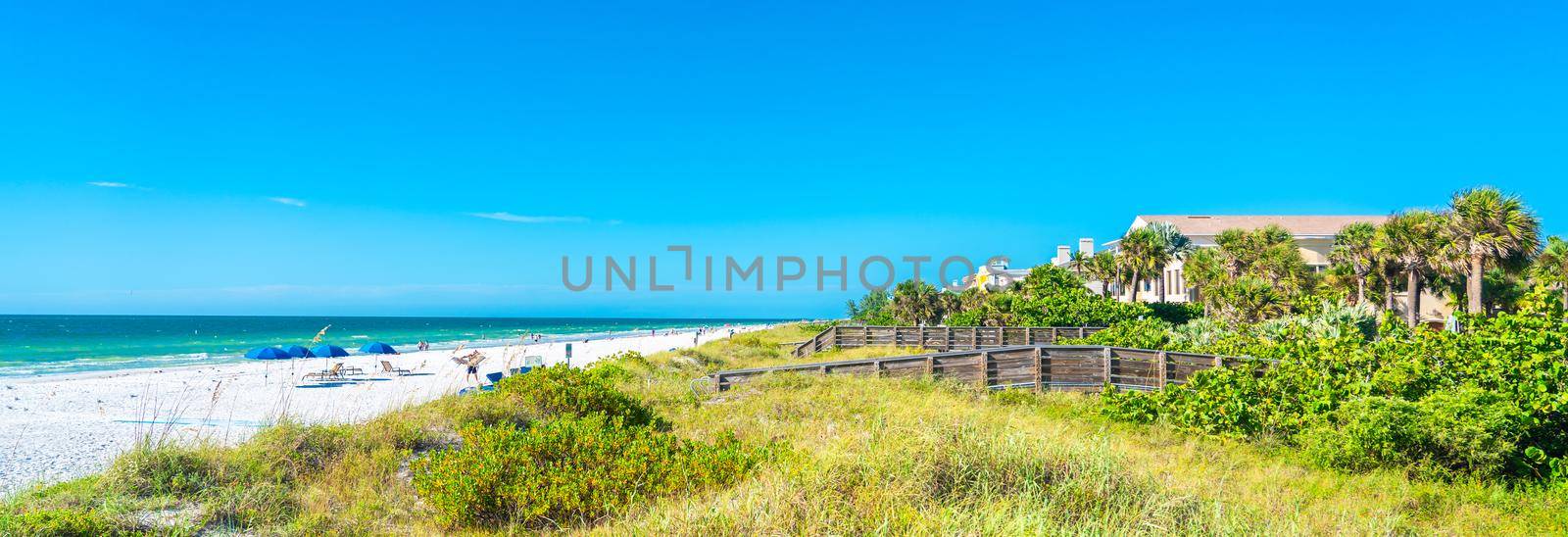 Indian rocks beach with green grass in Florida, USA by Mariakray