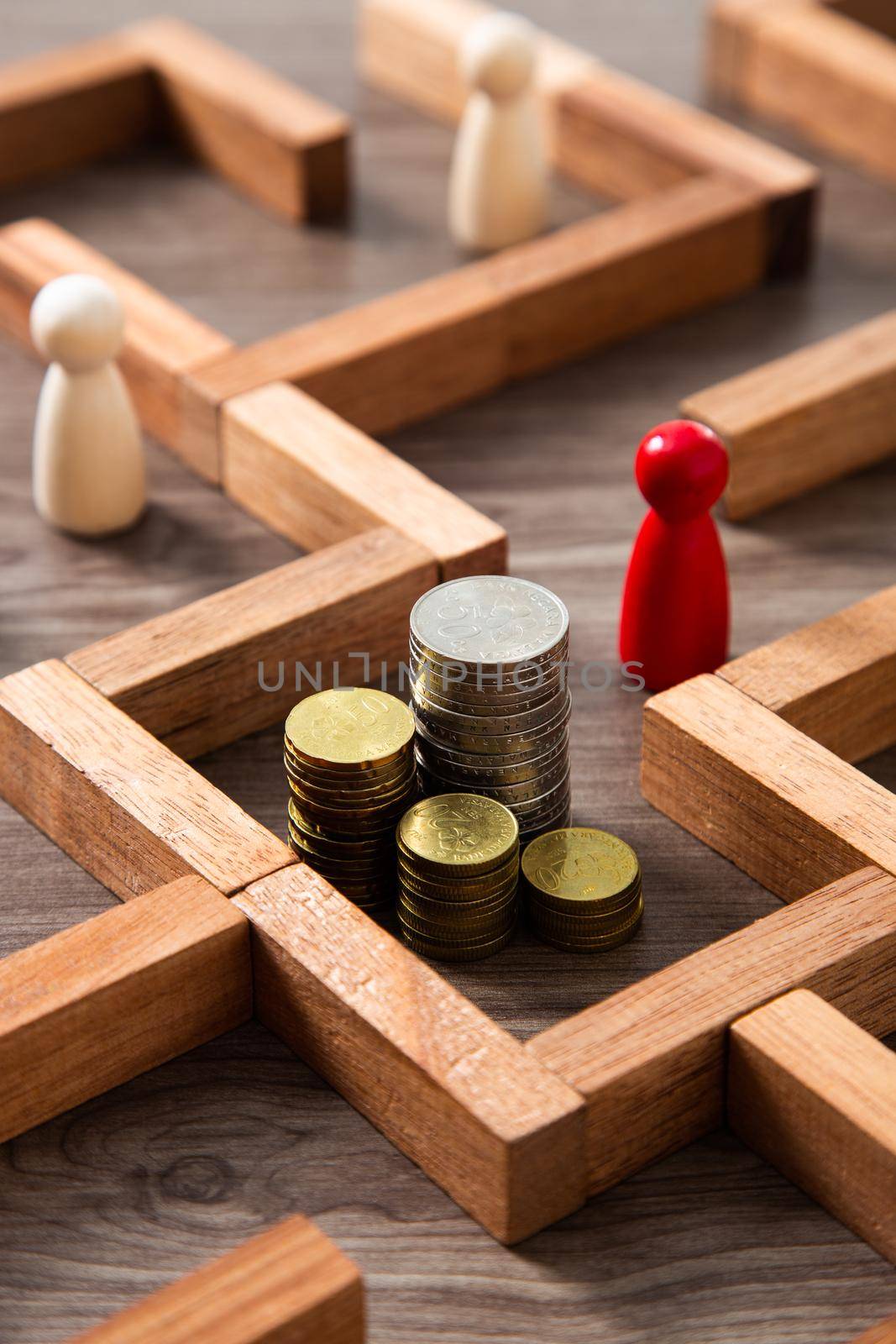 Group of coins heaps in the maze game built by wood blocks, find a way to money resource, business budget, making money concept