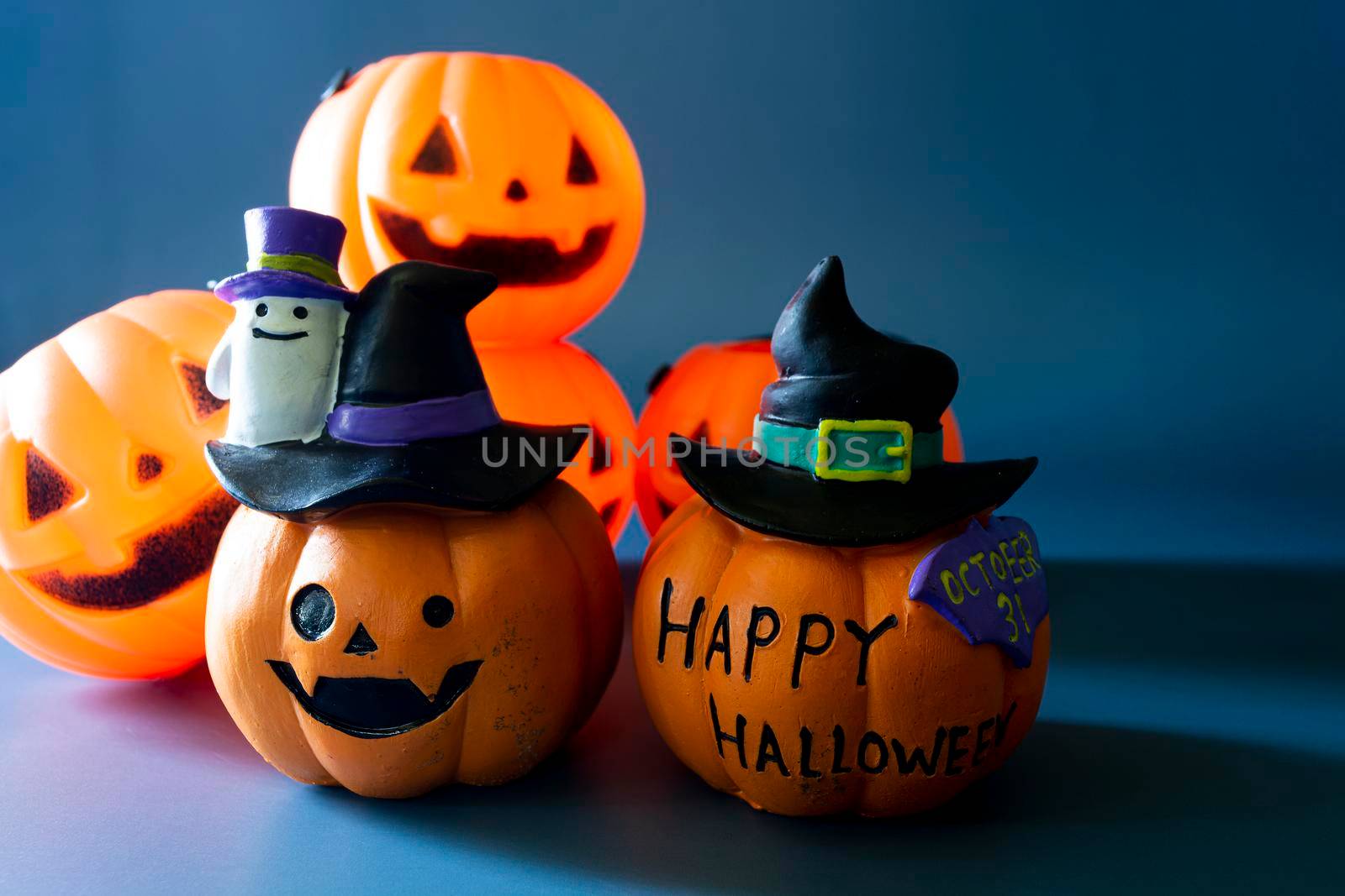 Jack o lantern pumpkin on a blue background. Halloween concept backdrop