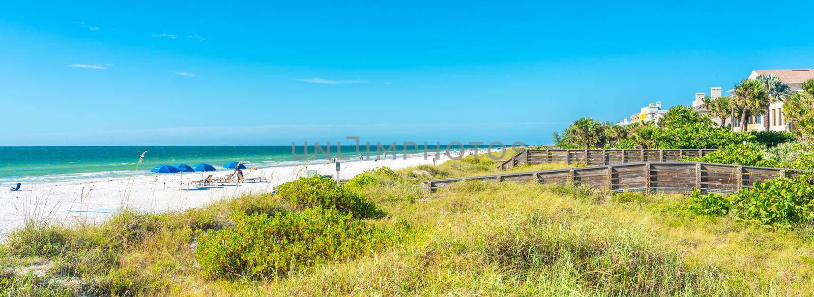 Indian rocks beach with green grass in Florida, USA by Mariakray
