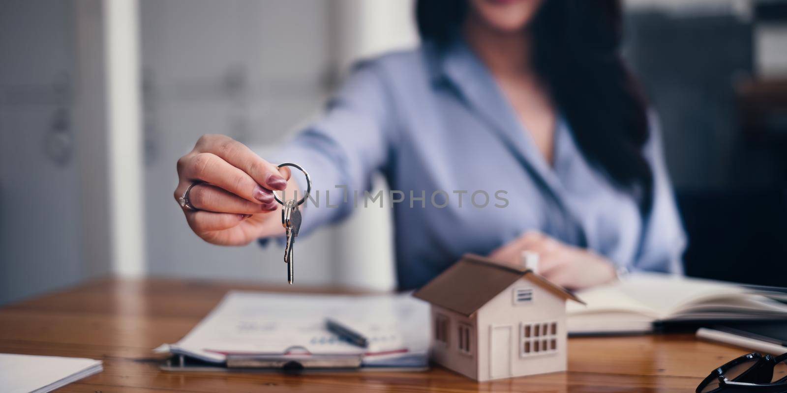 Real estate or broker residential or Agent showing key for house and car rent.