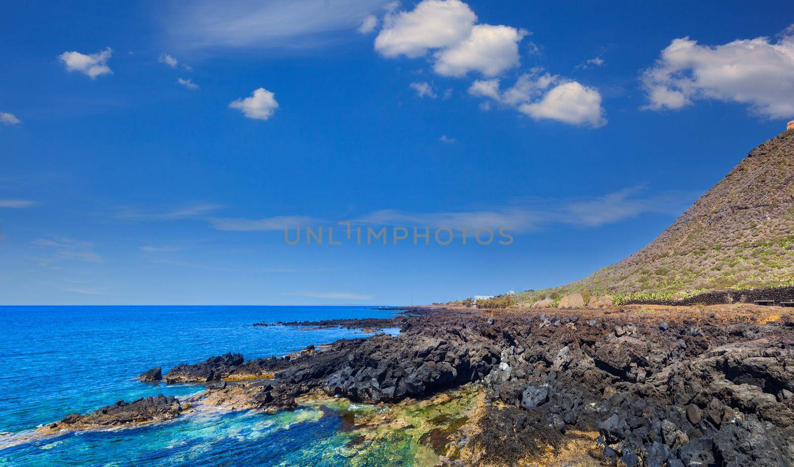 View of the scenic lava rock cliff in the Linosa island. Sicily