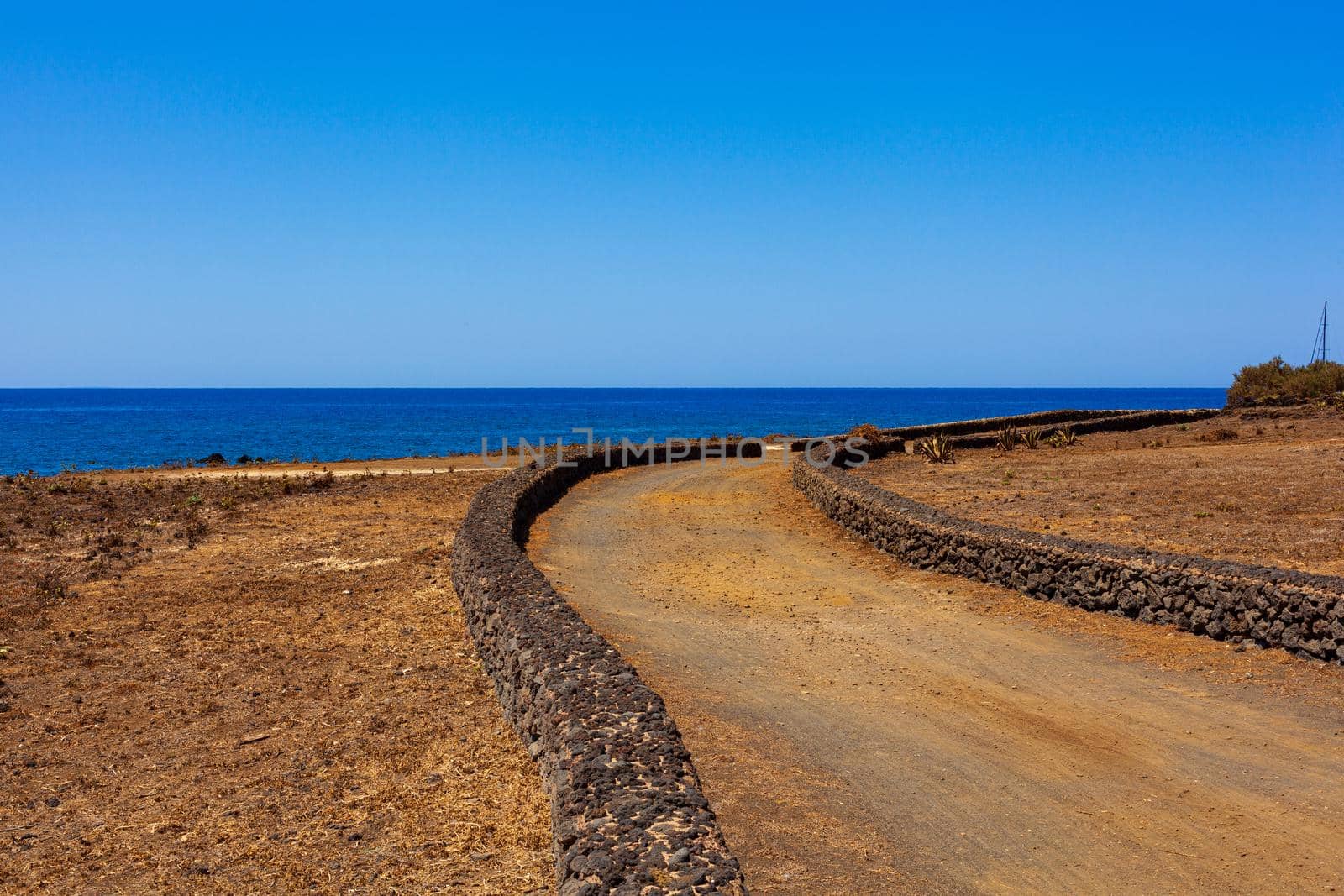 Road next to the sea in the Linosa island, Sicily by bepsimage