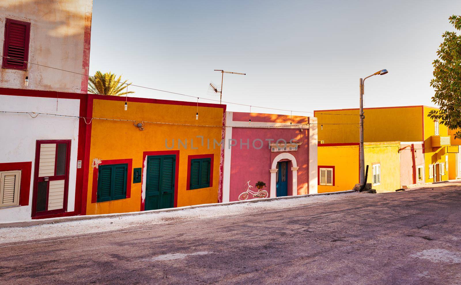 View of the Linosa houses at sunset in the summer season by bepsimage