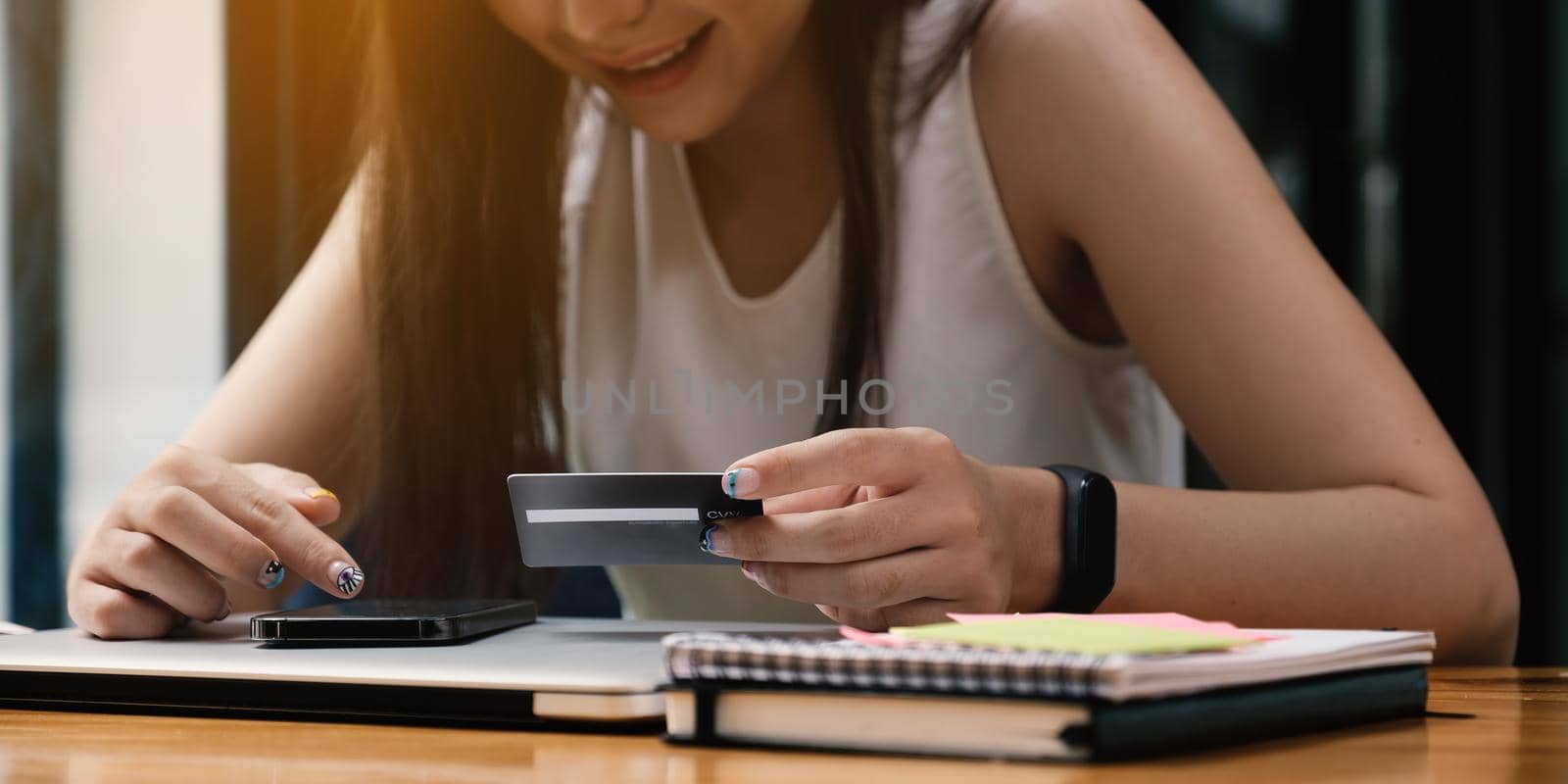 Woman enjoy with online shopping application and looking at credit card for fill number to payment by itchaznong