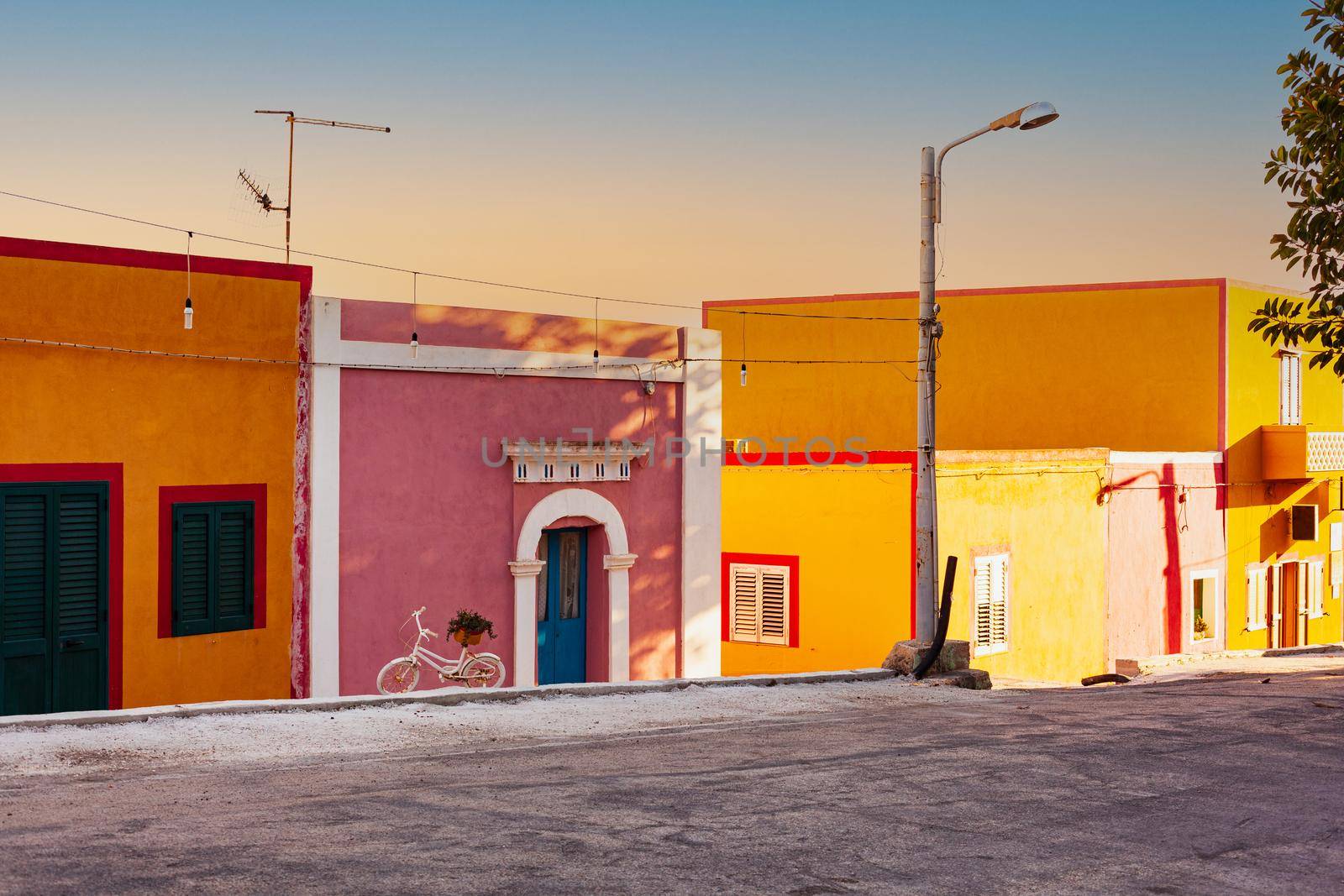 View of the Linosa houses at sunset in the summer season by bepsimage