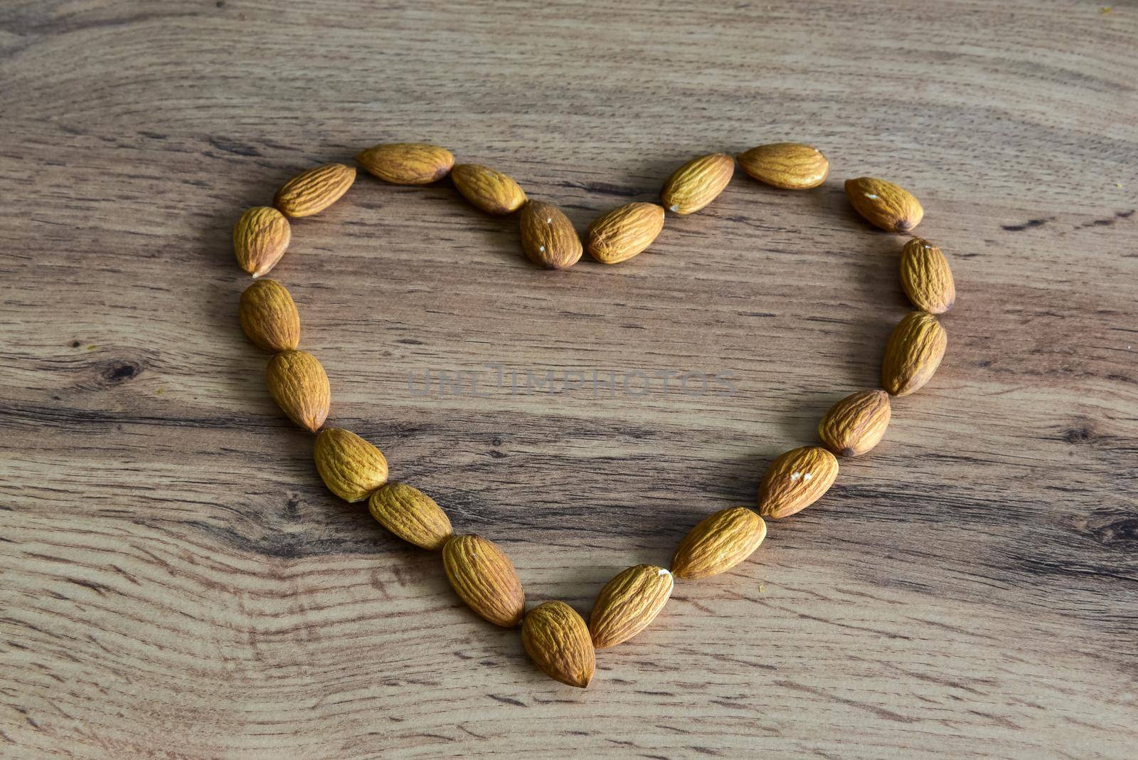 Almonds lying on the table in the form of a heart.