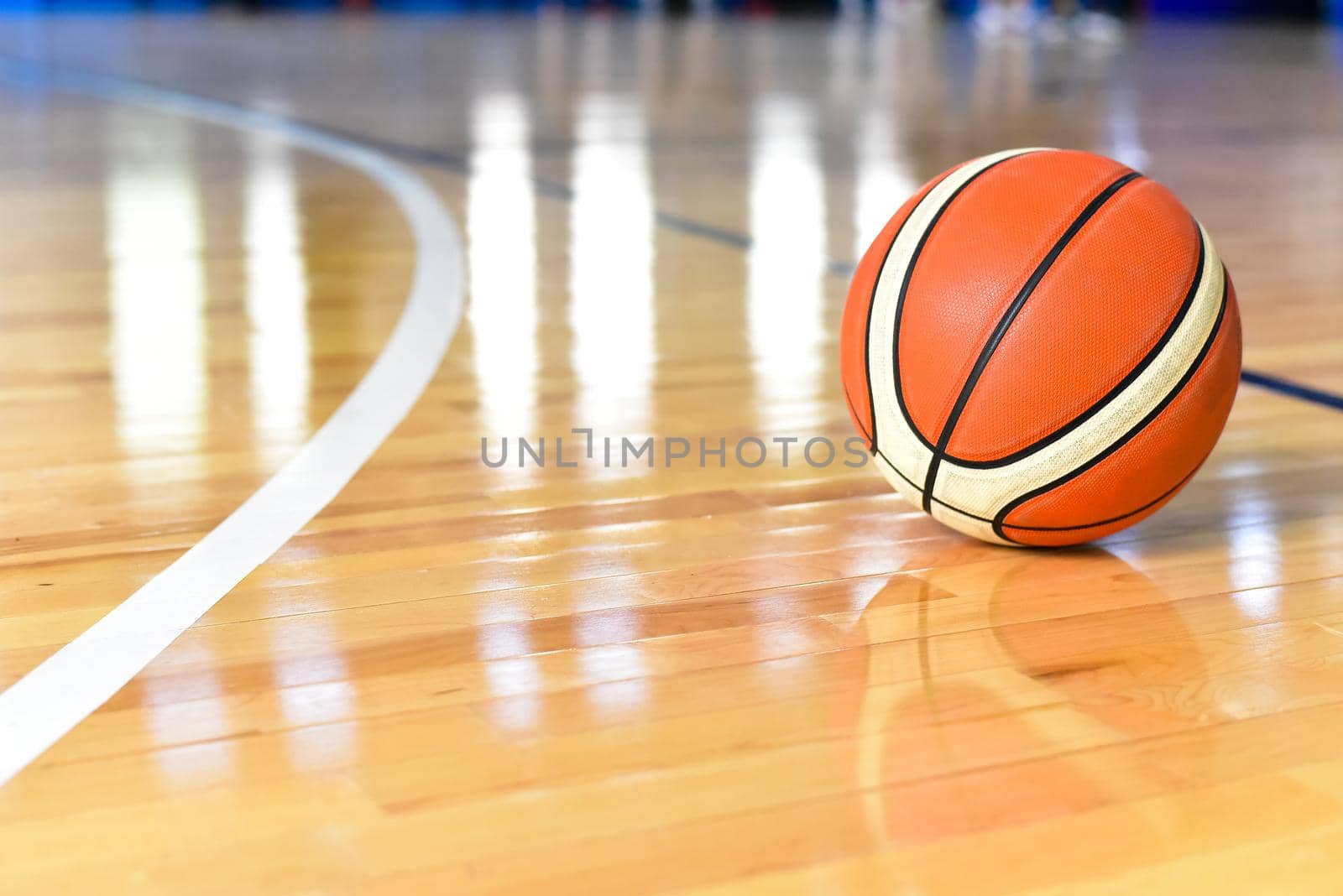 Basketball ball on Court Floor close up with blurred background.