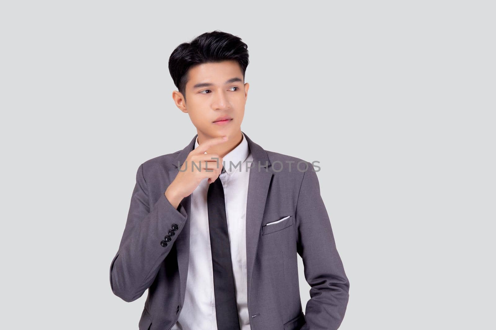 Portrait young asian business man in suit with smart thinking idea isolated on white background, businessman standing and planning for success, handsome manager or executive, emotion and expression. by nnudoo