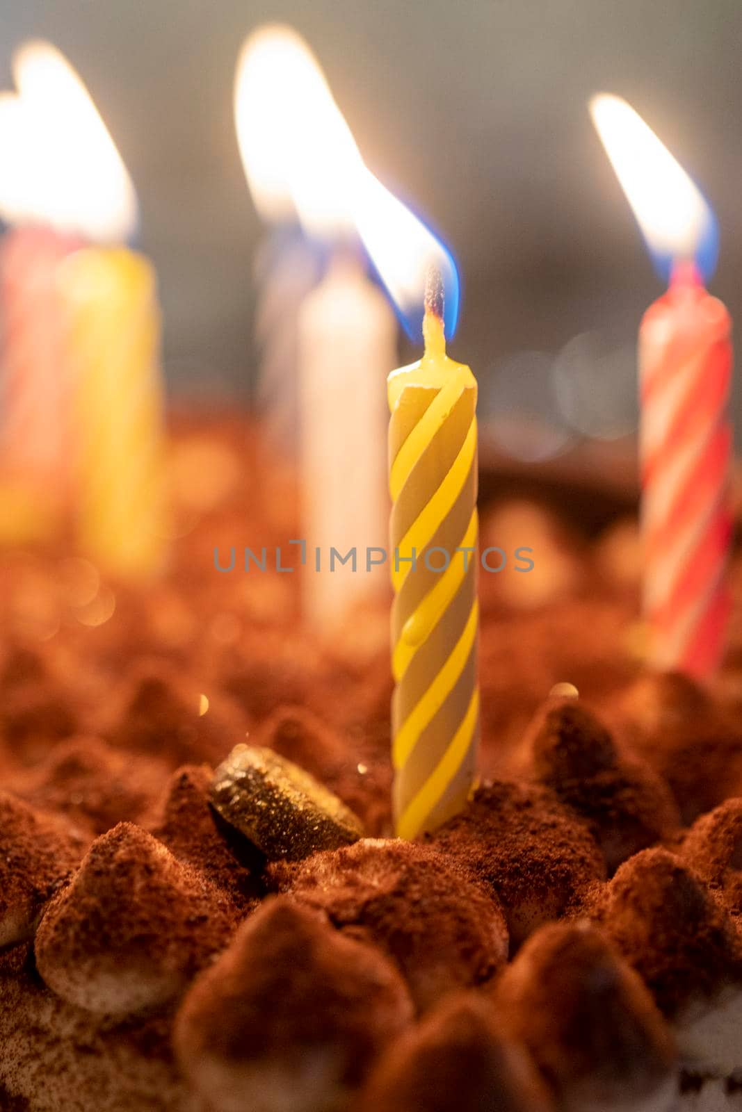 Festive background with burning candles in the cake by Vvicca