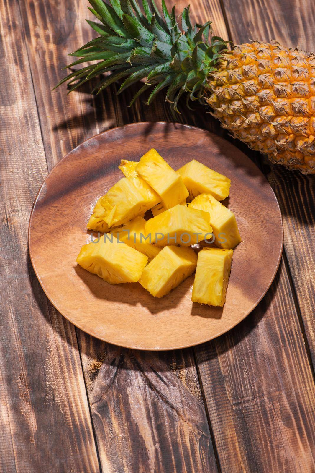 Tropical fruit concept. Cutted pineapple on the old wooden background. 