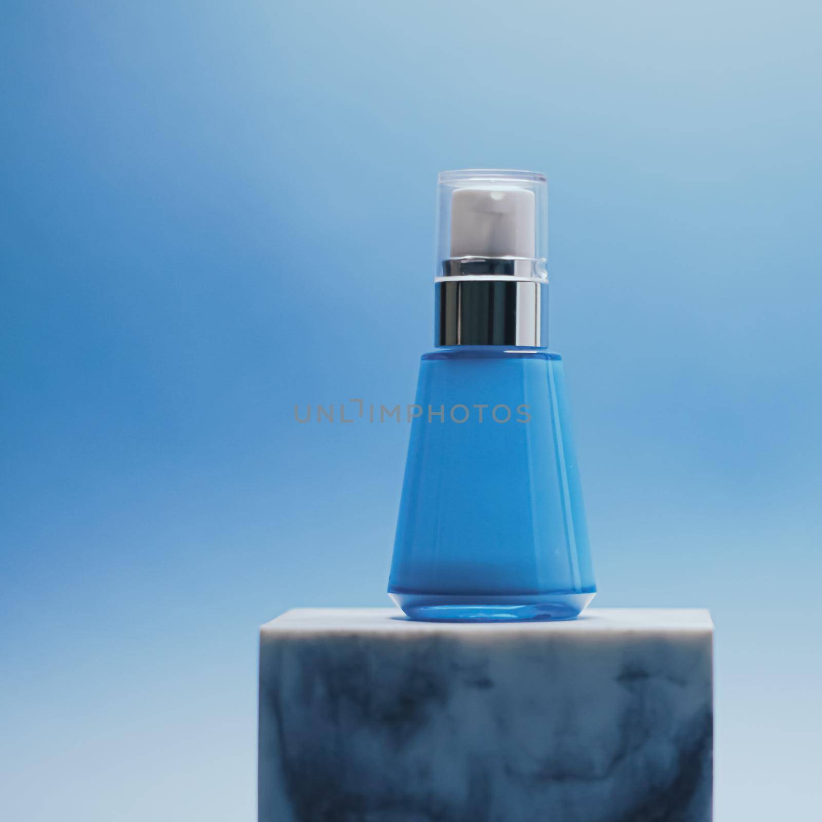 Serum bottle on blue background, luxury skincare products, beauty and cosmetics by Anneleven