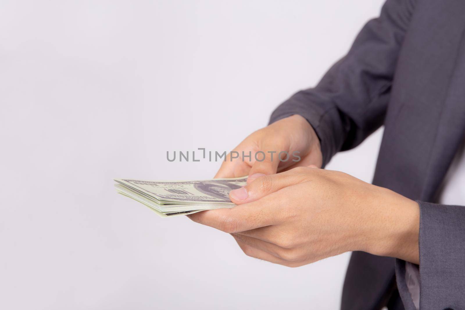 Hand of business man giving money isolated on white background, finance and cash, businessman holding banknotes dollar, deposit and loans, profit bonus and success, currency and exchange.