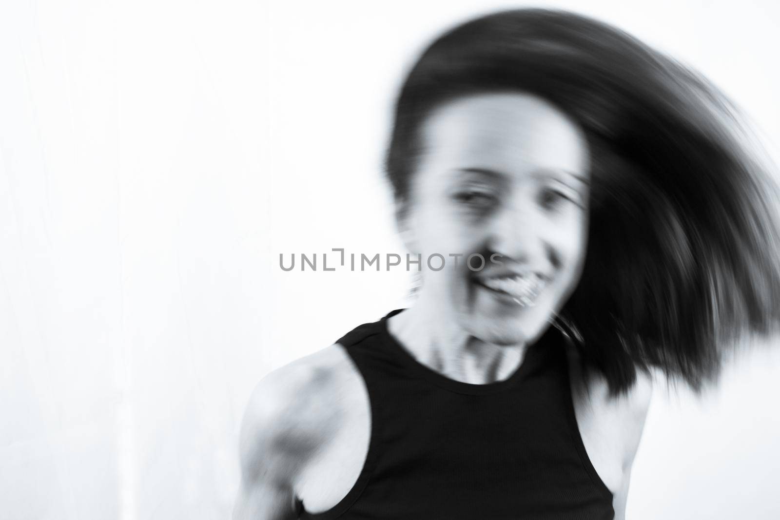 Motion blur portrait of woman over 40. Black tshirt