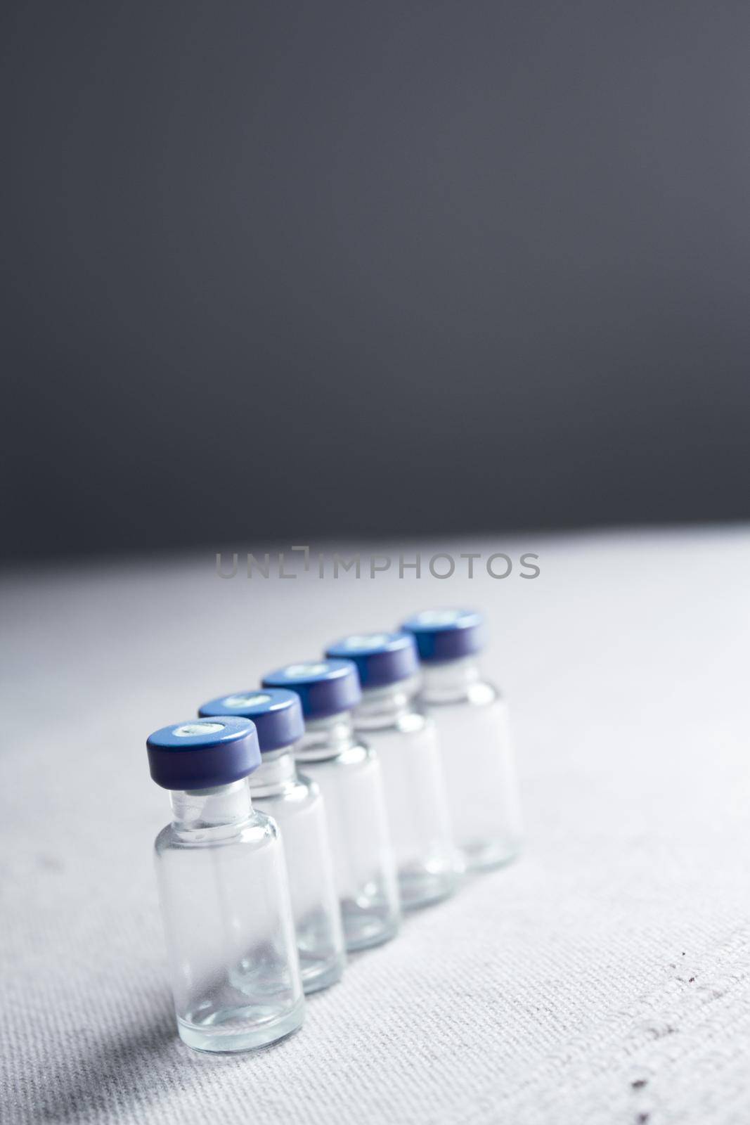 Empty glass jars of coronavirus vaccines. No people