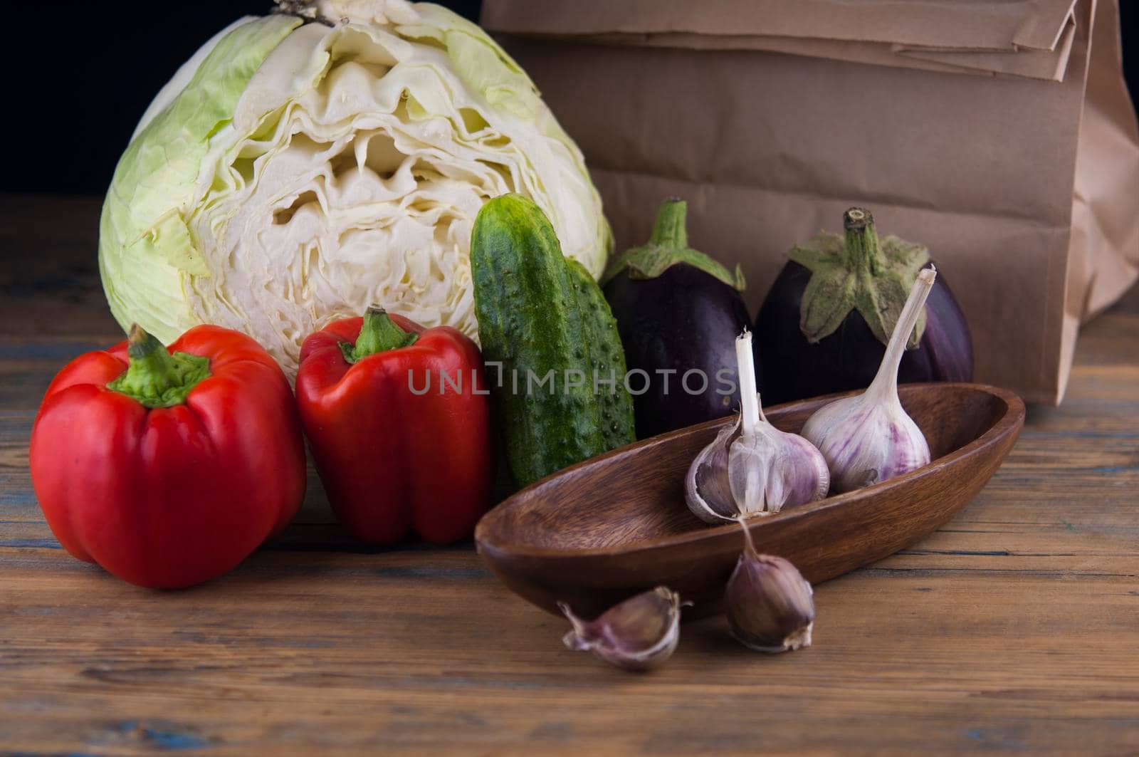 Organic vegetables still life scene on wood table by inxti