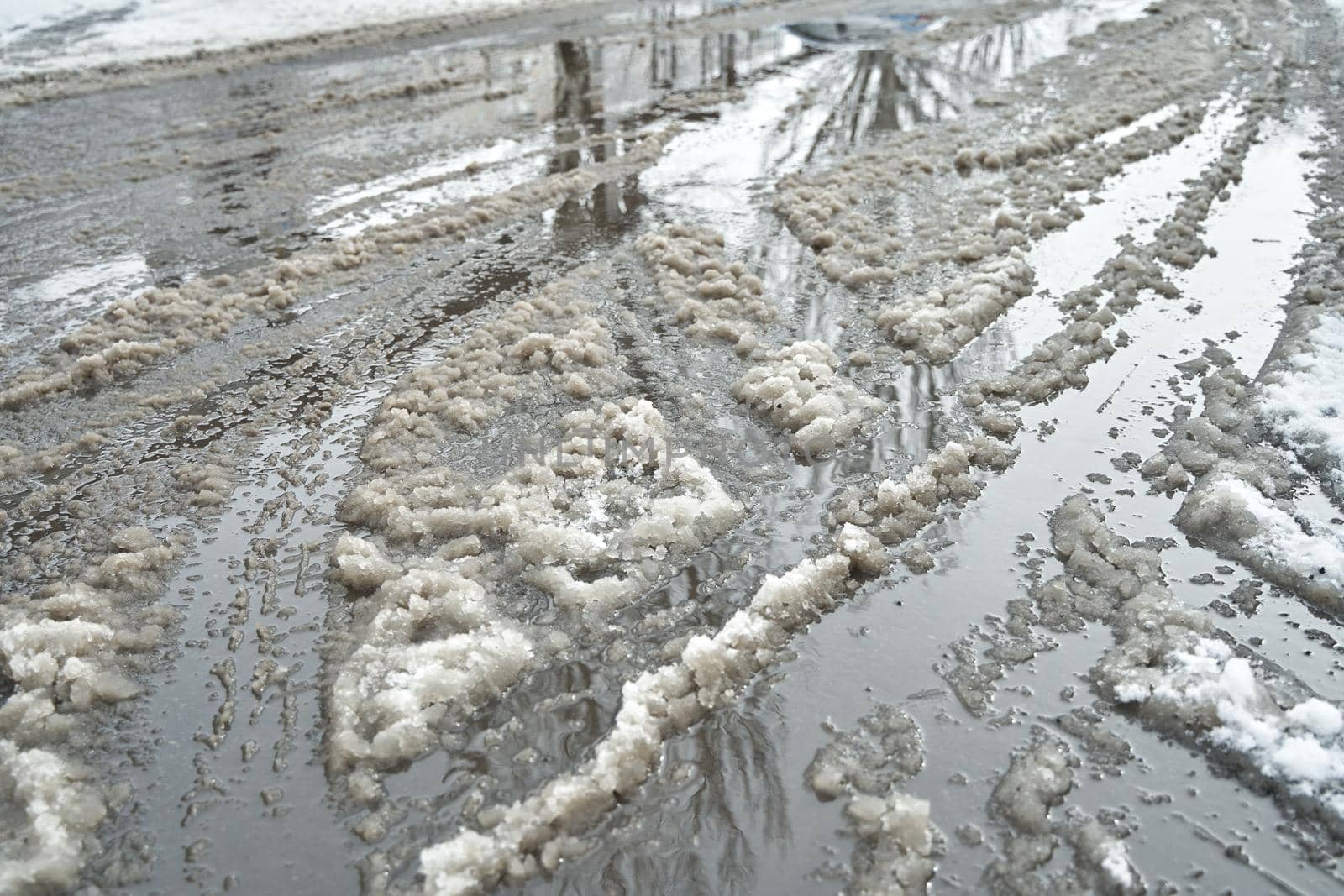 Slush on the road during winter snowfall.