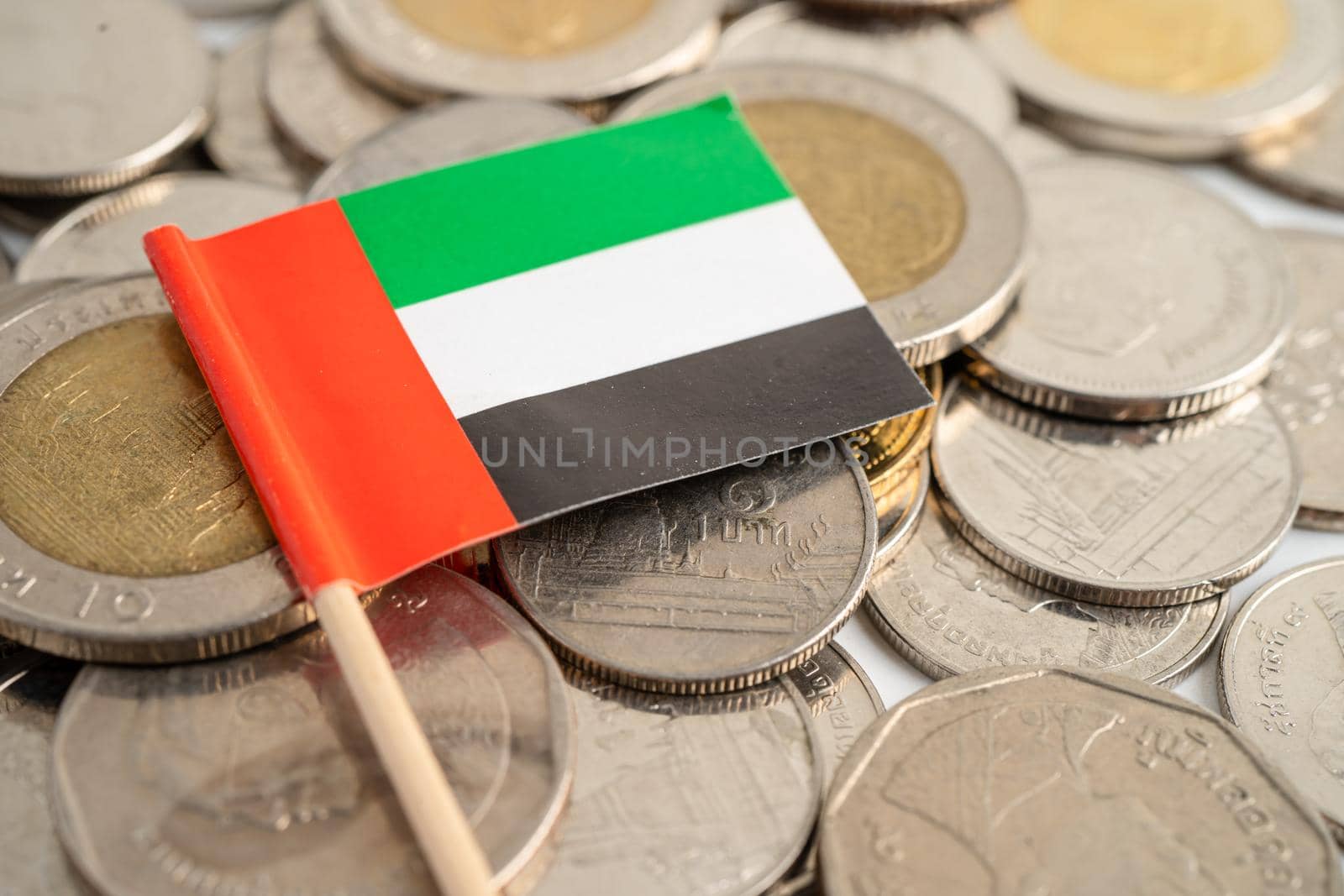 Stack of coins with Arab Emirates flag on white background. flag on white background. by pamai