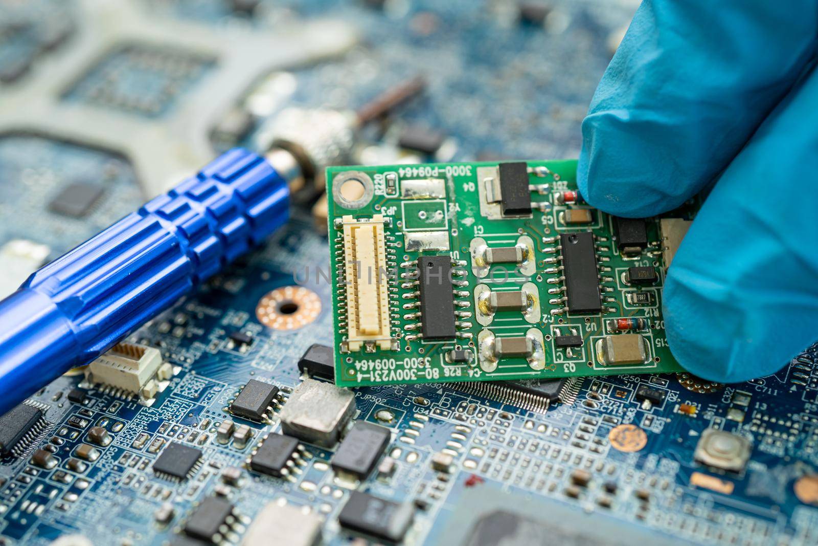 Repairing inside of hard disk by soldering iron. Integrated Circuit. the concept of data, hardware, technician and technology. by pamai